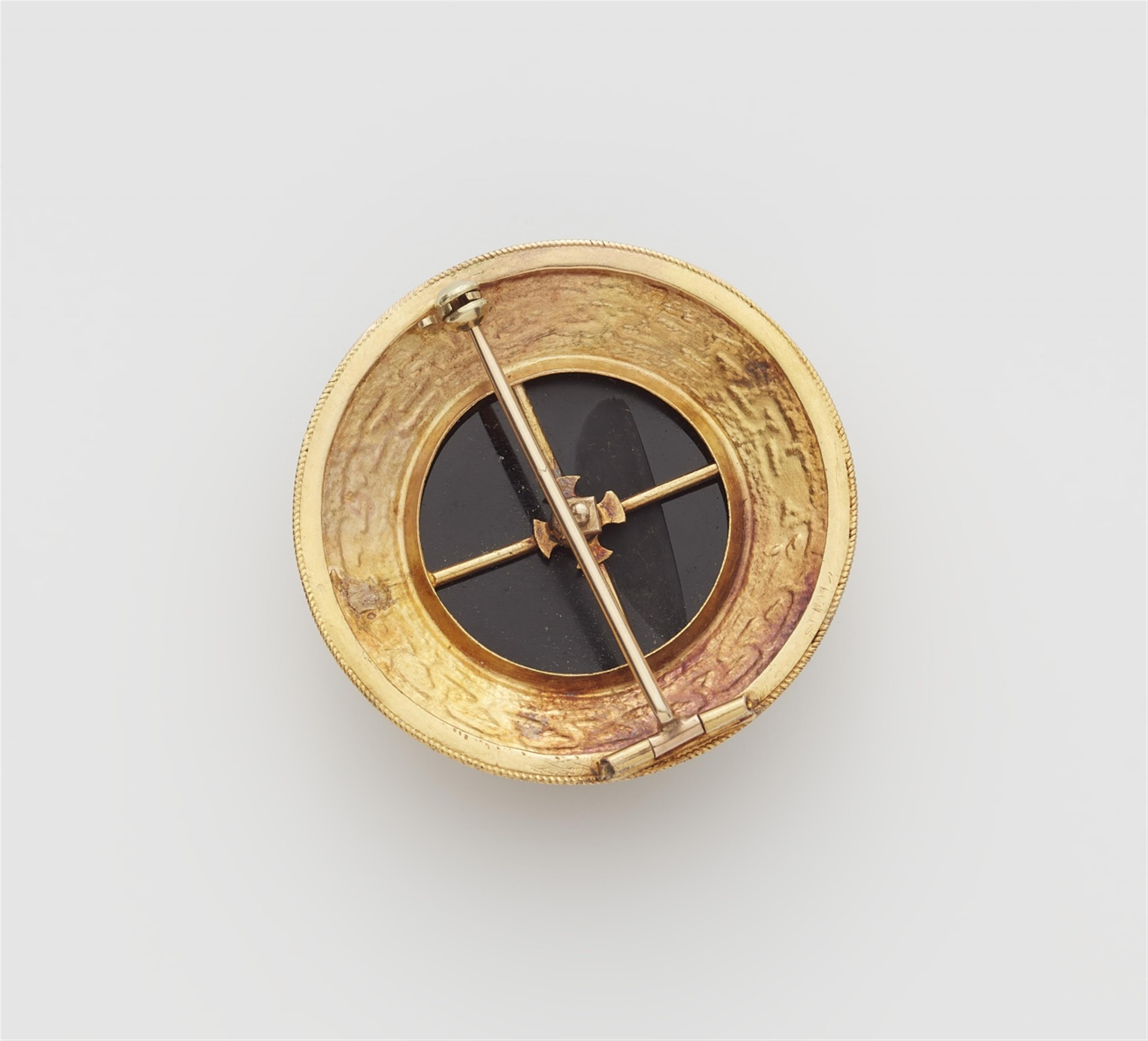 A 14k gold and onyx brooch with a diamond solitaire - image-2