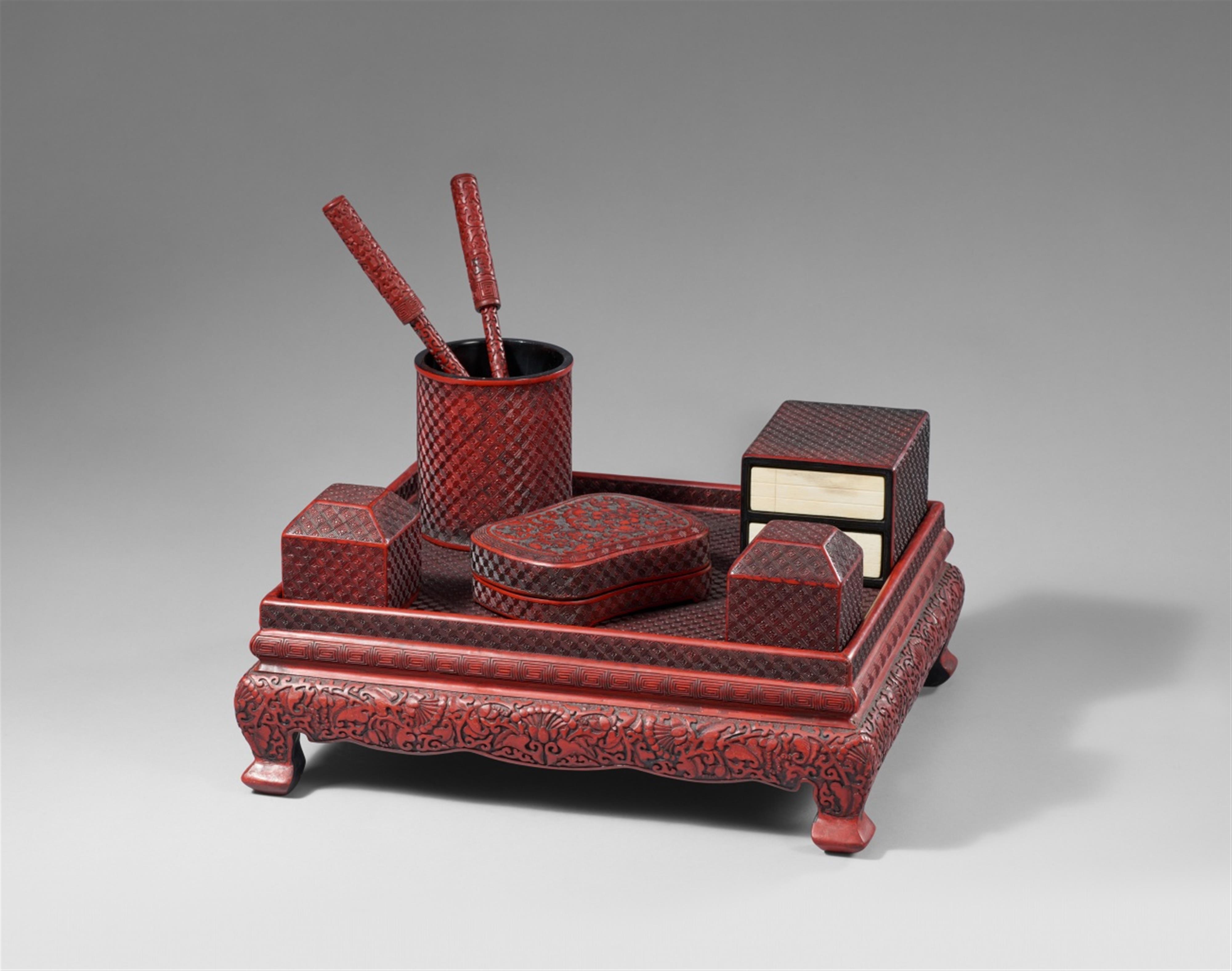 A set of writing objects on a table in the manner of carved red lacquer. 20th century - image-1