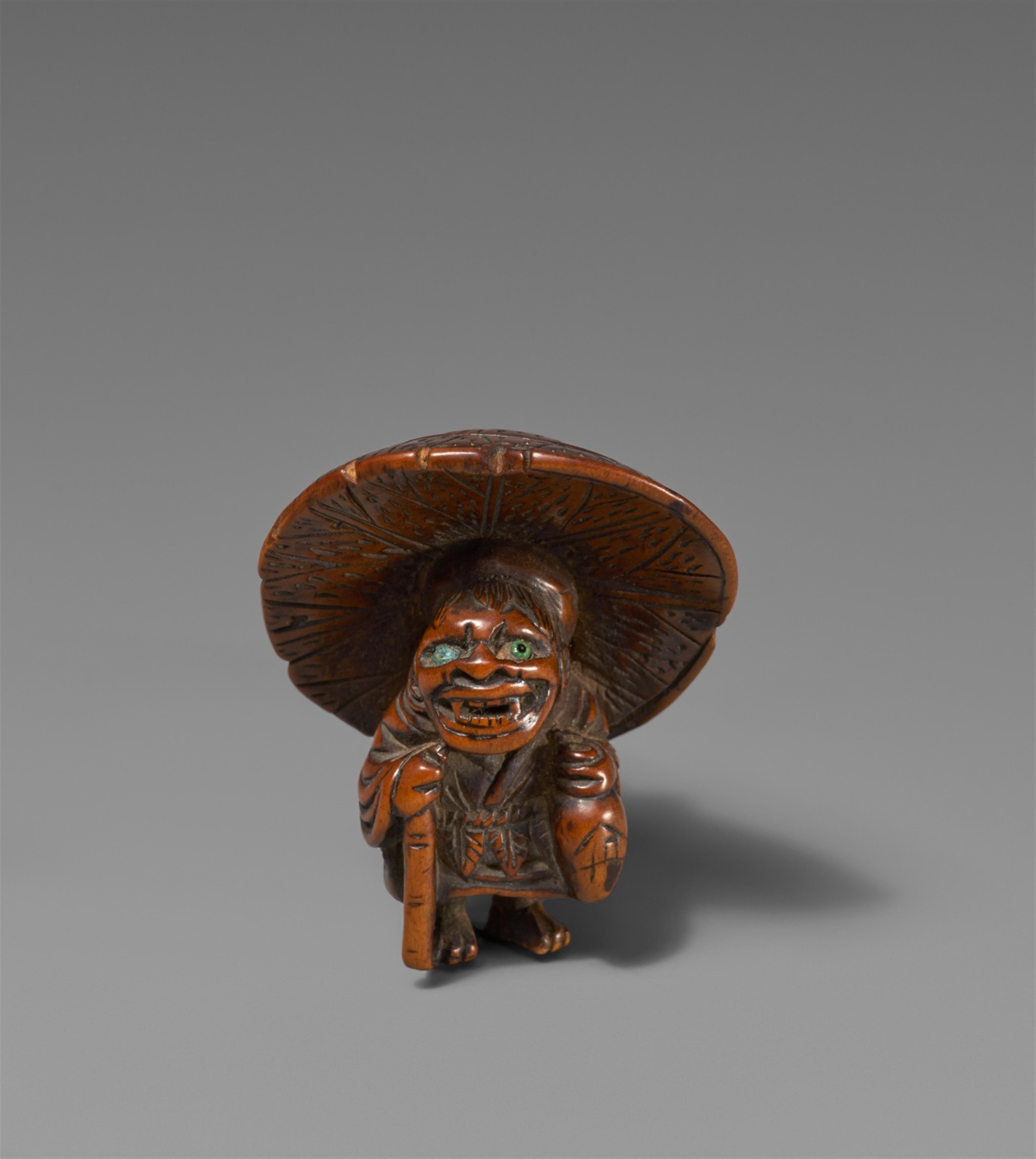 A boxwood netsuke of an oni with a tokkuri. 19th century - image-1