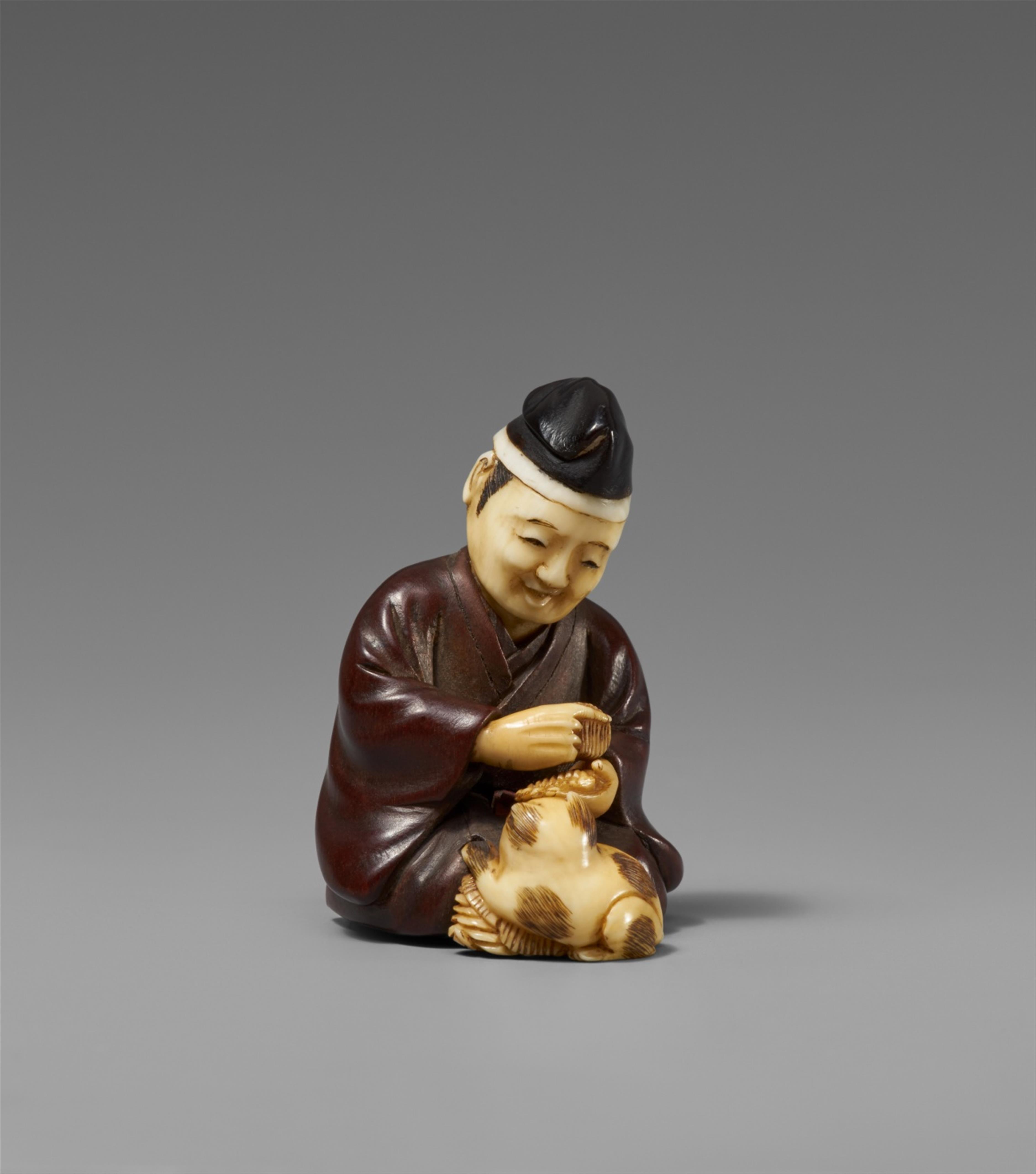 A wood and ivory netsuke of a courtier with a puppy. Late 19th century - image-1