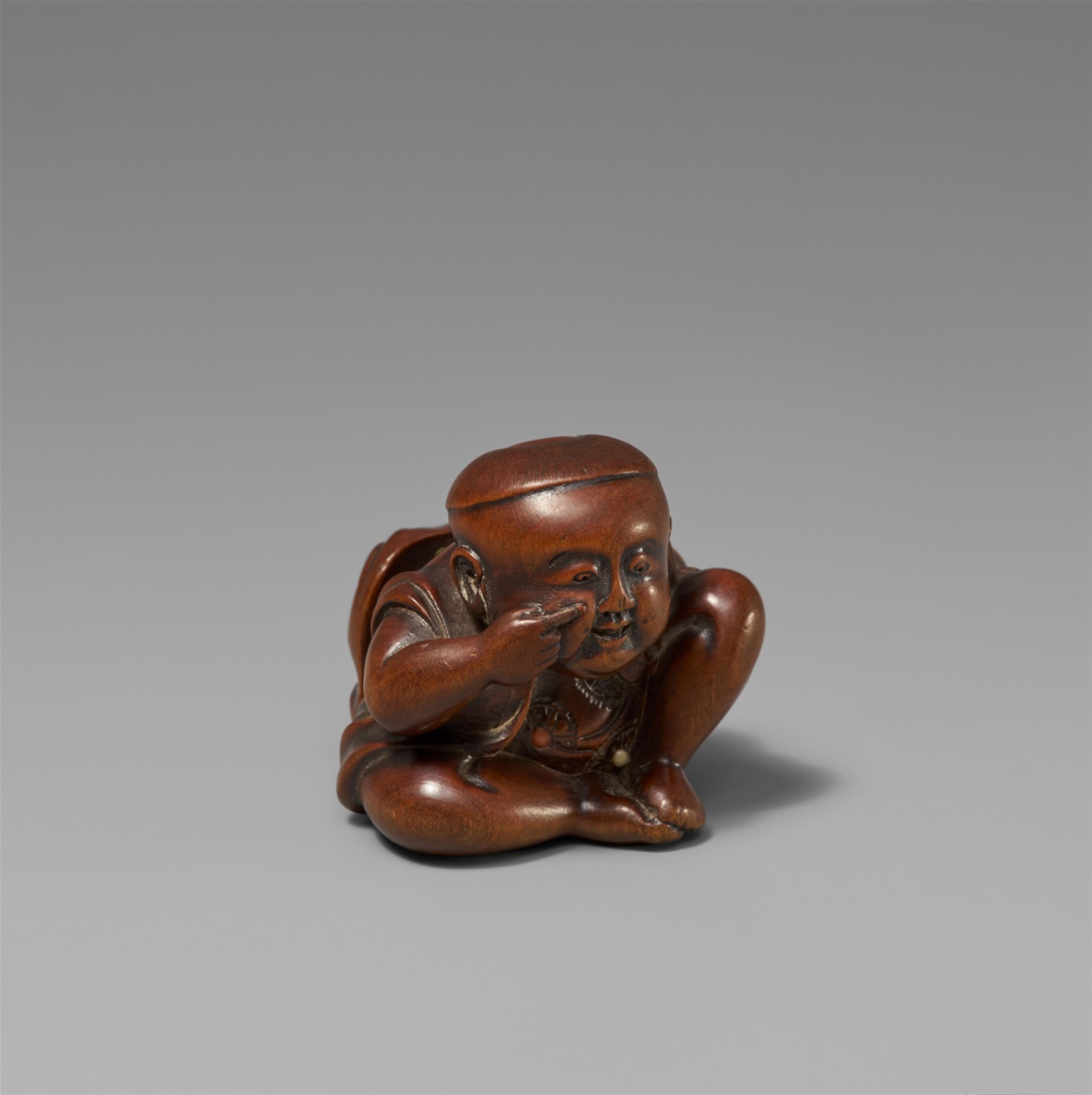 A boxwood netsuke of a boy with a Buaku mask. Mid-19th century - image-1