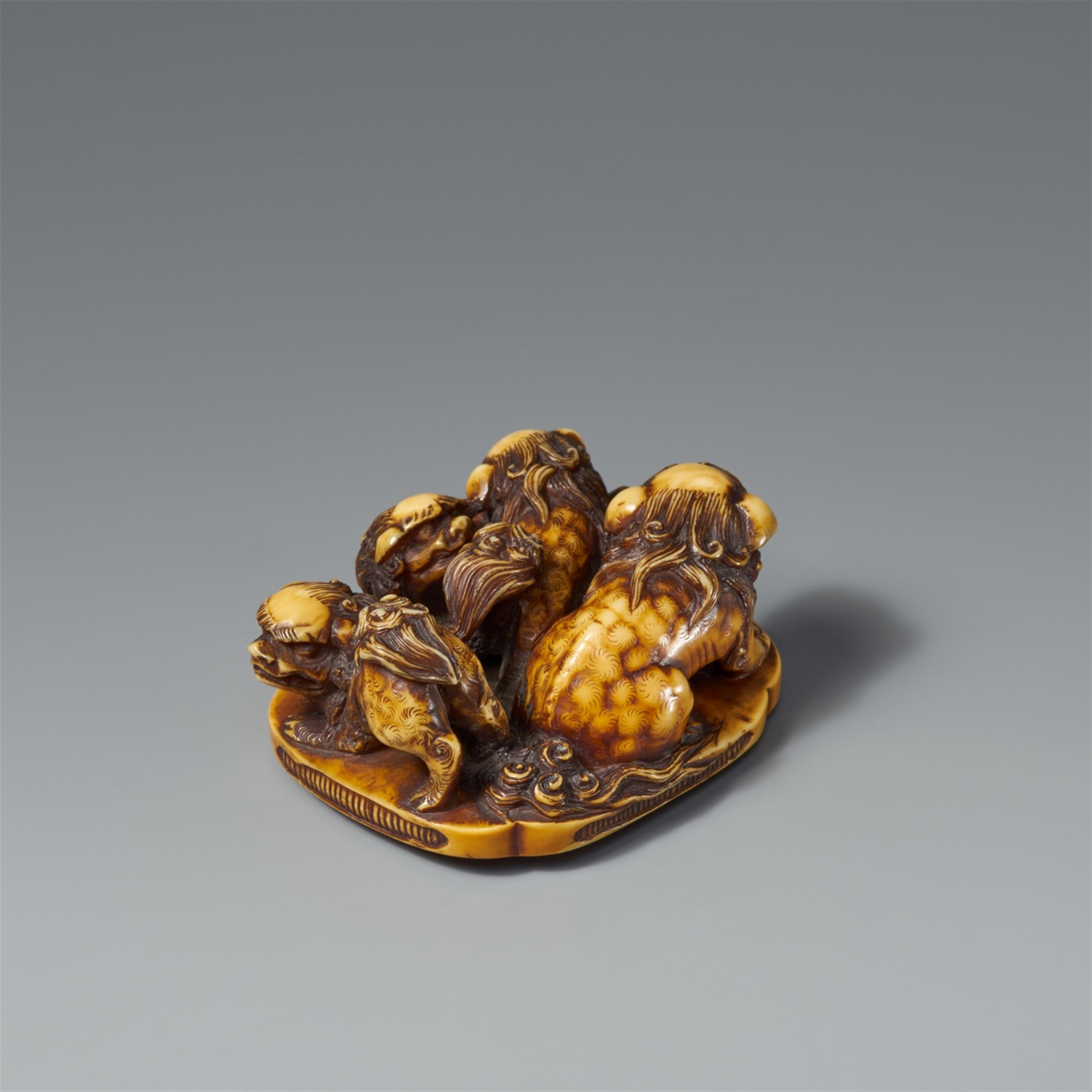 A large stained ivory netsuke of a group of four shishi. Second half 19th century - image-2