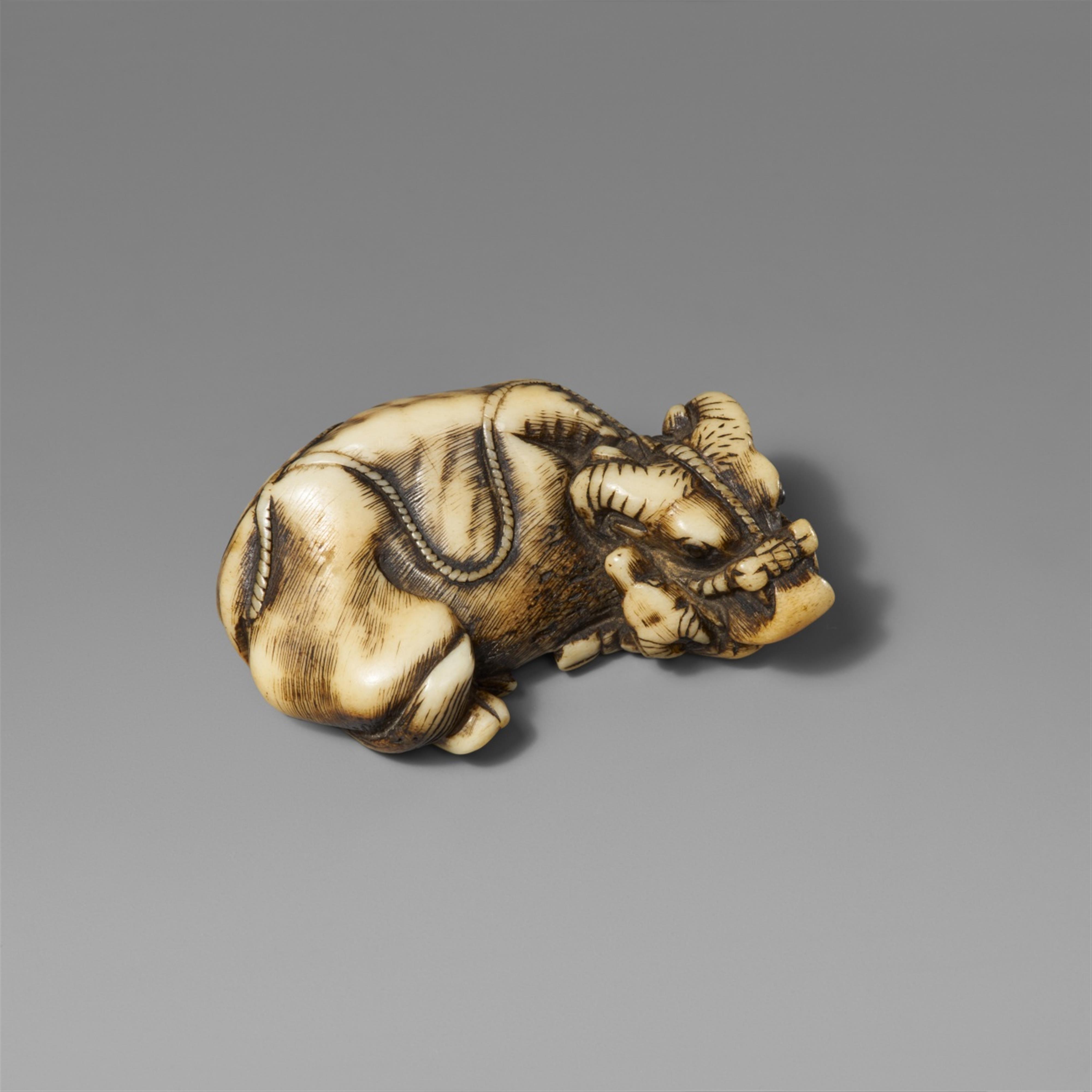 A stag antler netsuke of a recumbent ox with calf. Early 19th century  - image-1