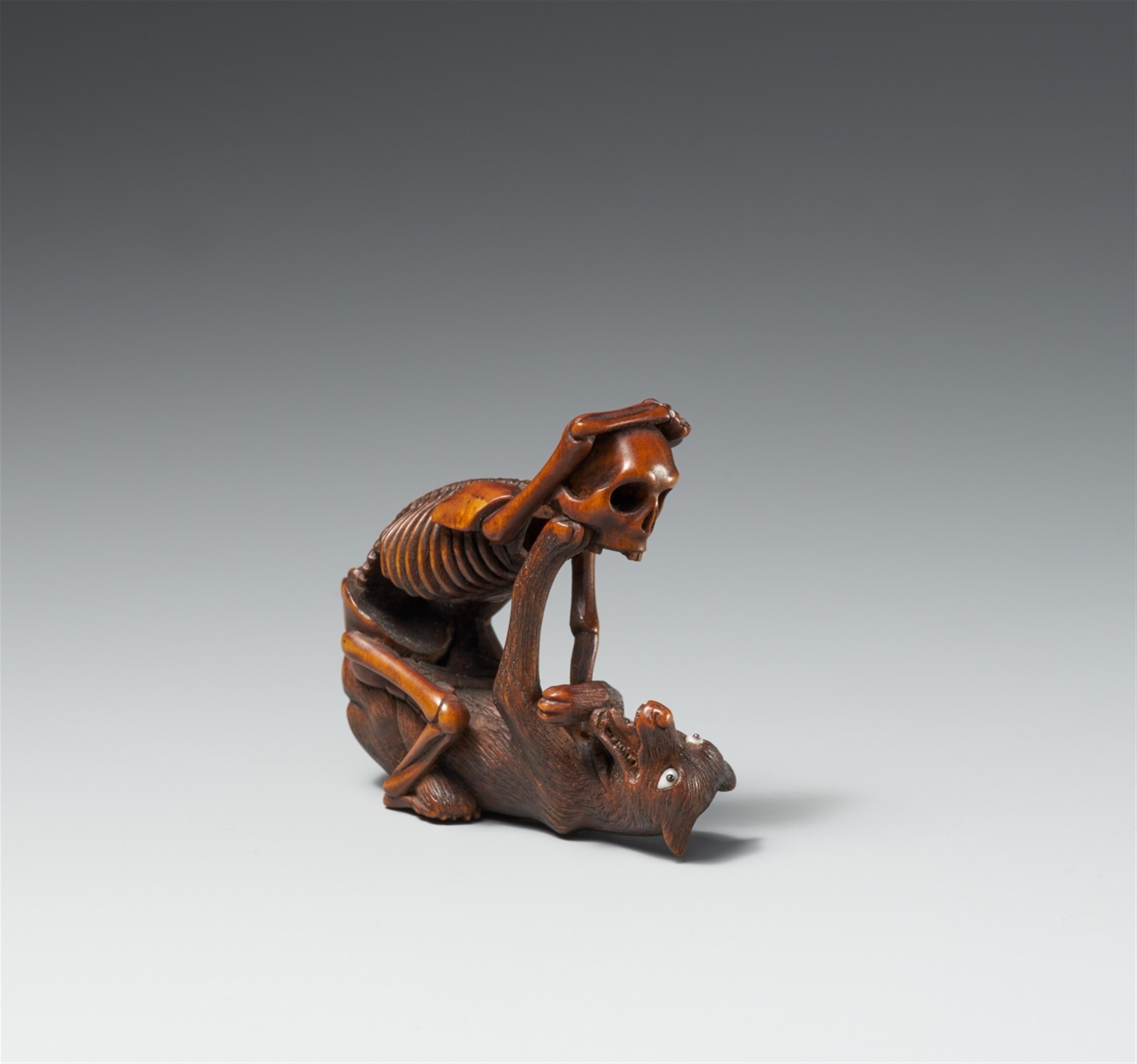 A Hida school boxwood netsuke of a skeleton and a wolf, in the manner of Shoko. Late 19th century - image-1