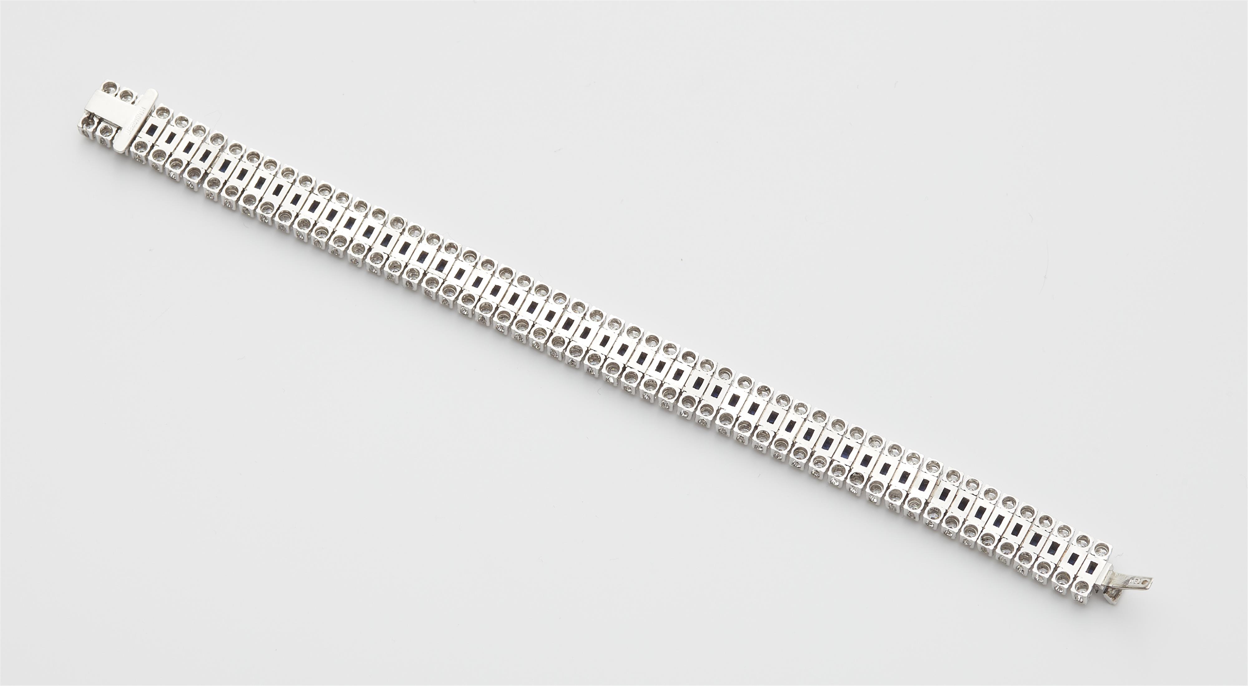 An 18k white gold diamond and sapphire bracelet. - image-2