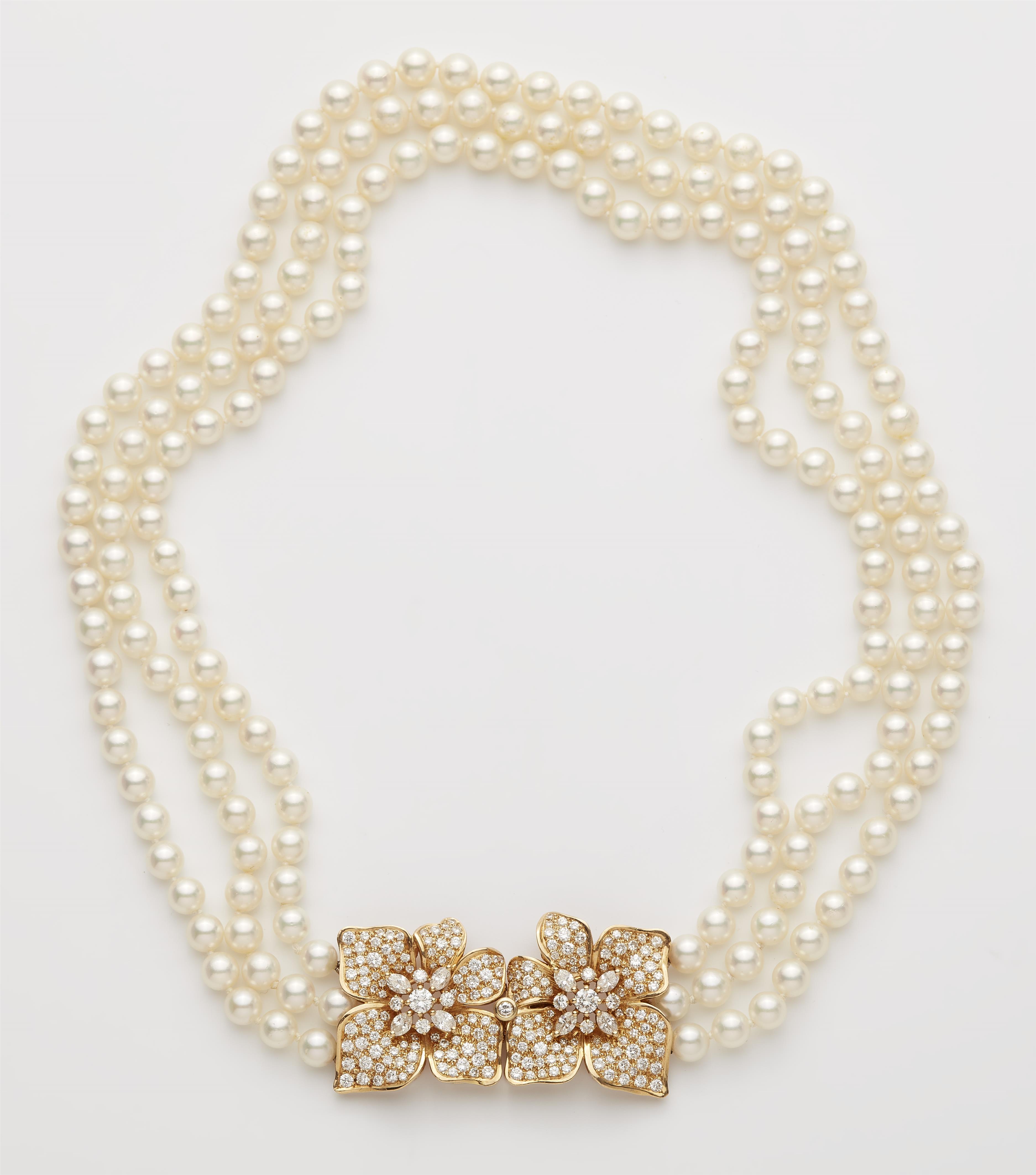 A French cultured pearl necklace with an 18k gold and diamond flower clasp. - image-1