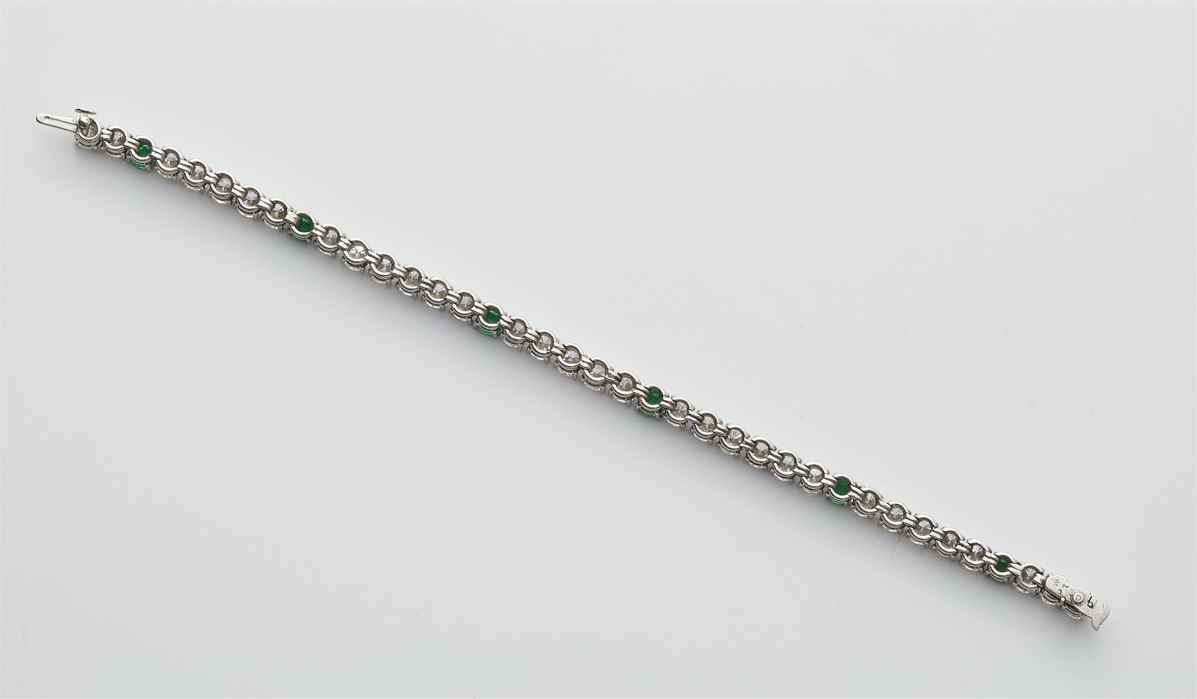 A platinum diamond and emerald rivière bracelet. - image-3