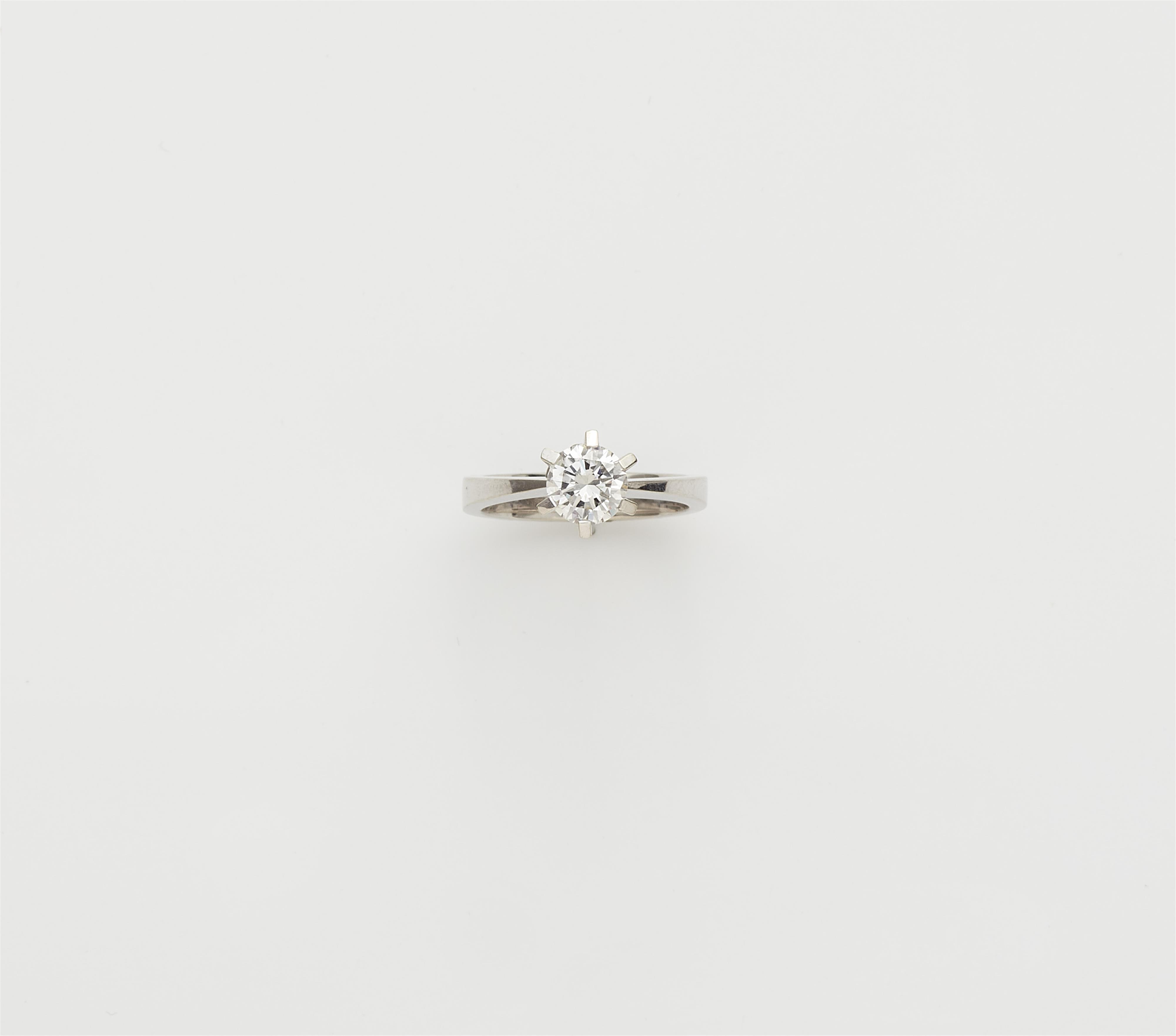 An 18k white gold diamond solitaire ring. - image-1