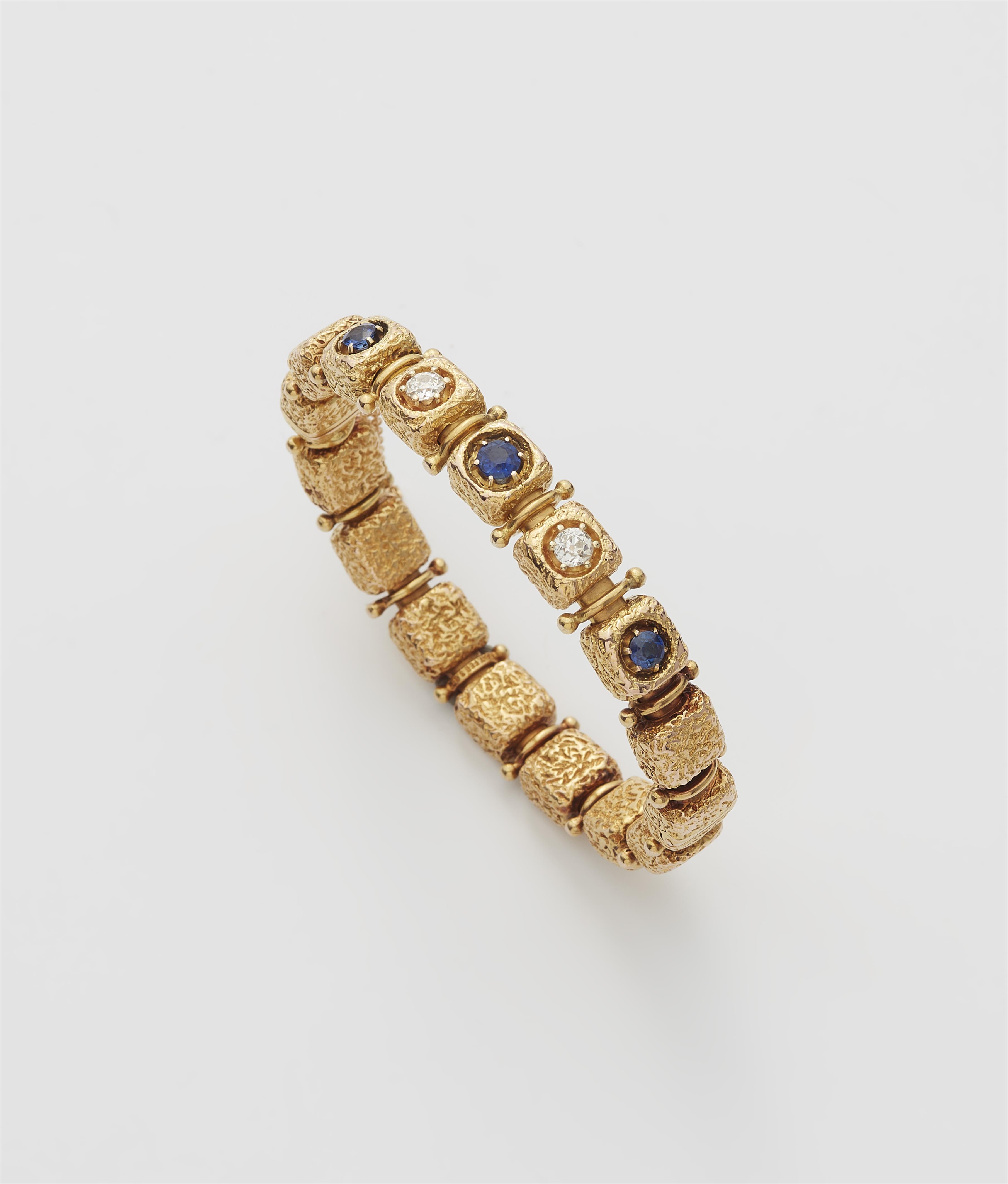 A 14k gold sapphire and diamond bangle. - image-1
