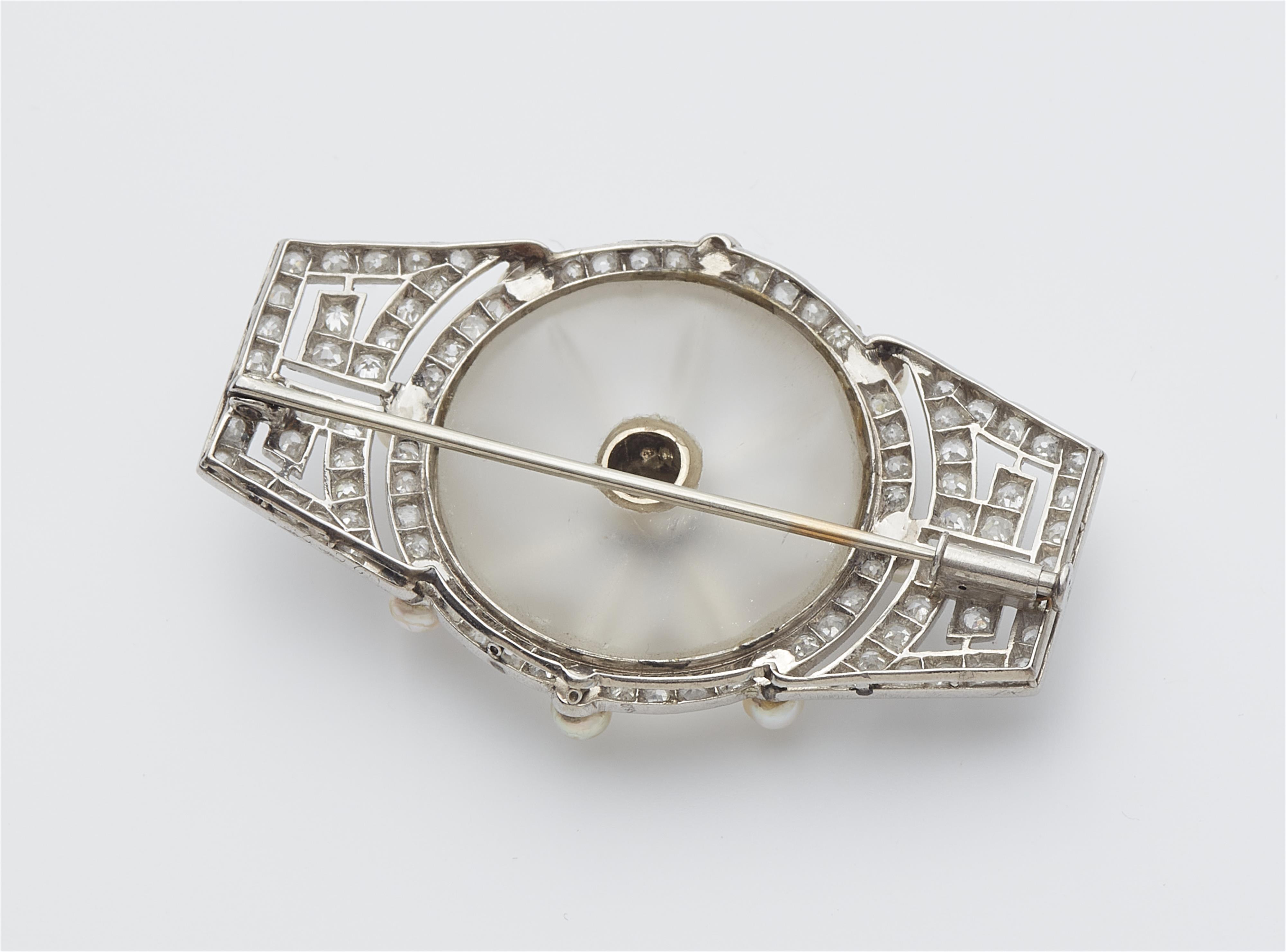 A French Art Déco platinum enamel diamond and rock crystal brooch. - image-2