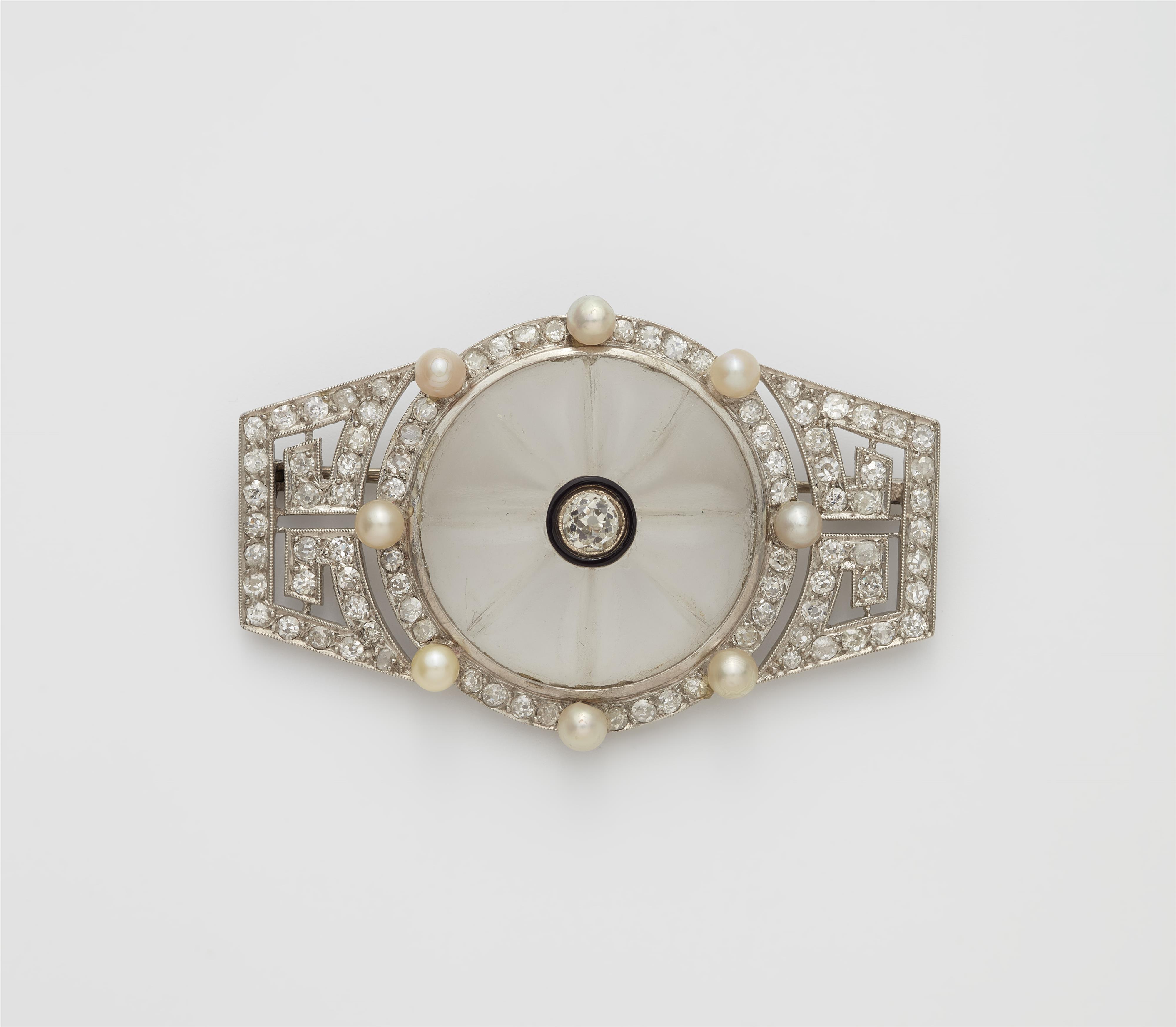 A French Art Déco platinum enamel diamond and rock crystal brooch. - image-1