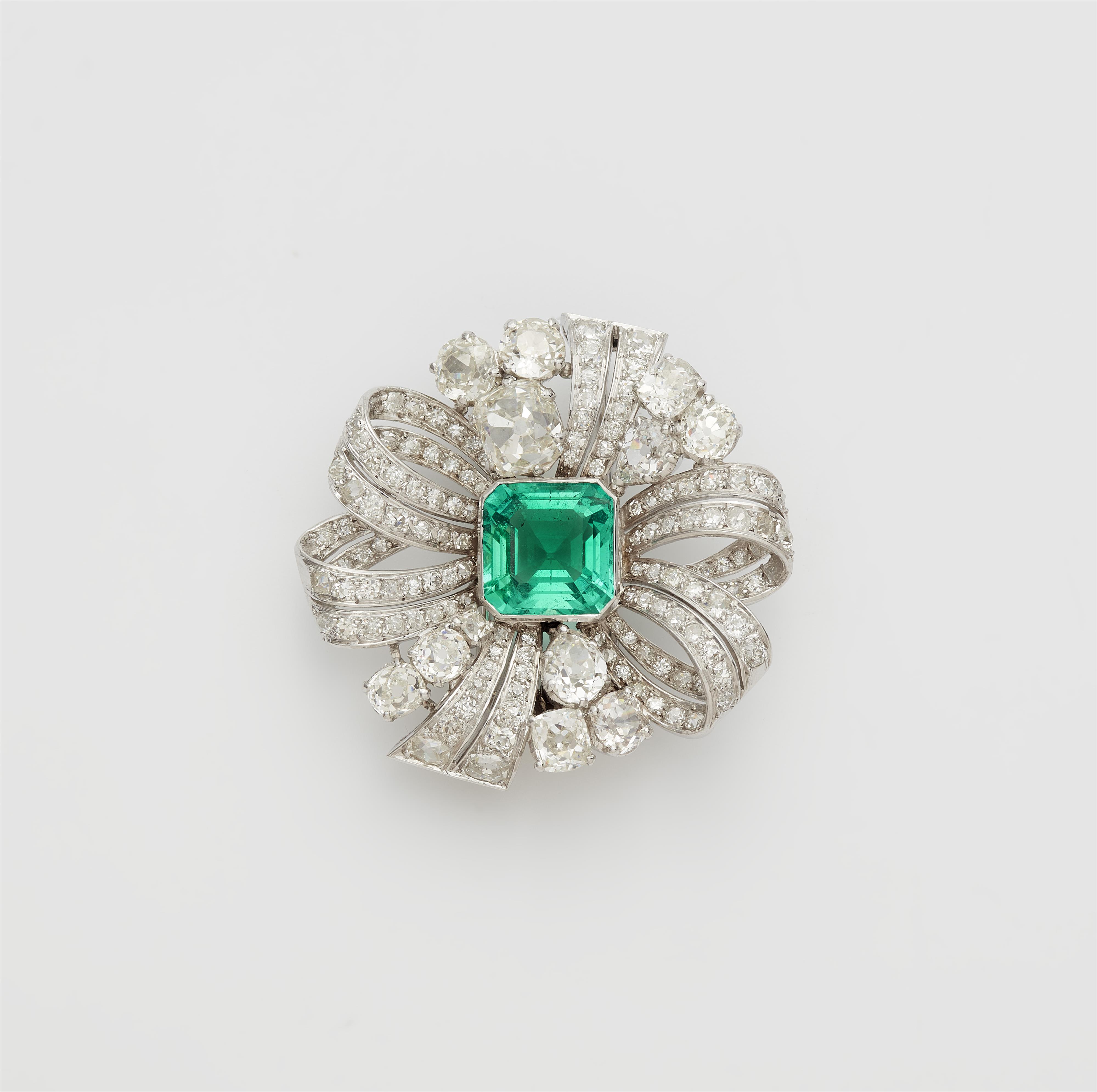 An 18k white gold diamond rosette brooch with a fine Columbian emerald and milanaise meshwork necklace. - image-1