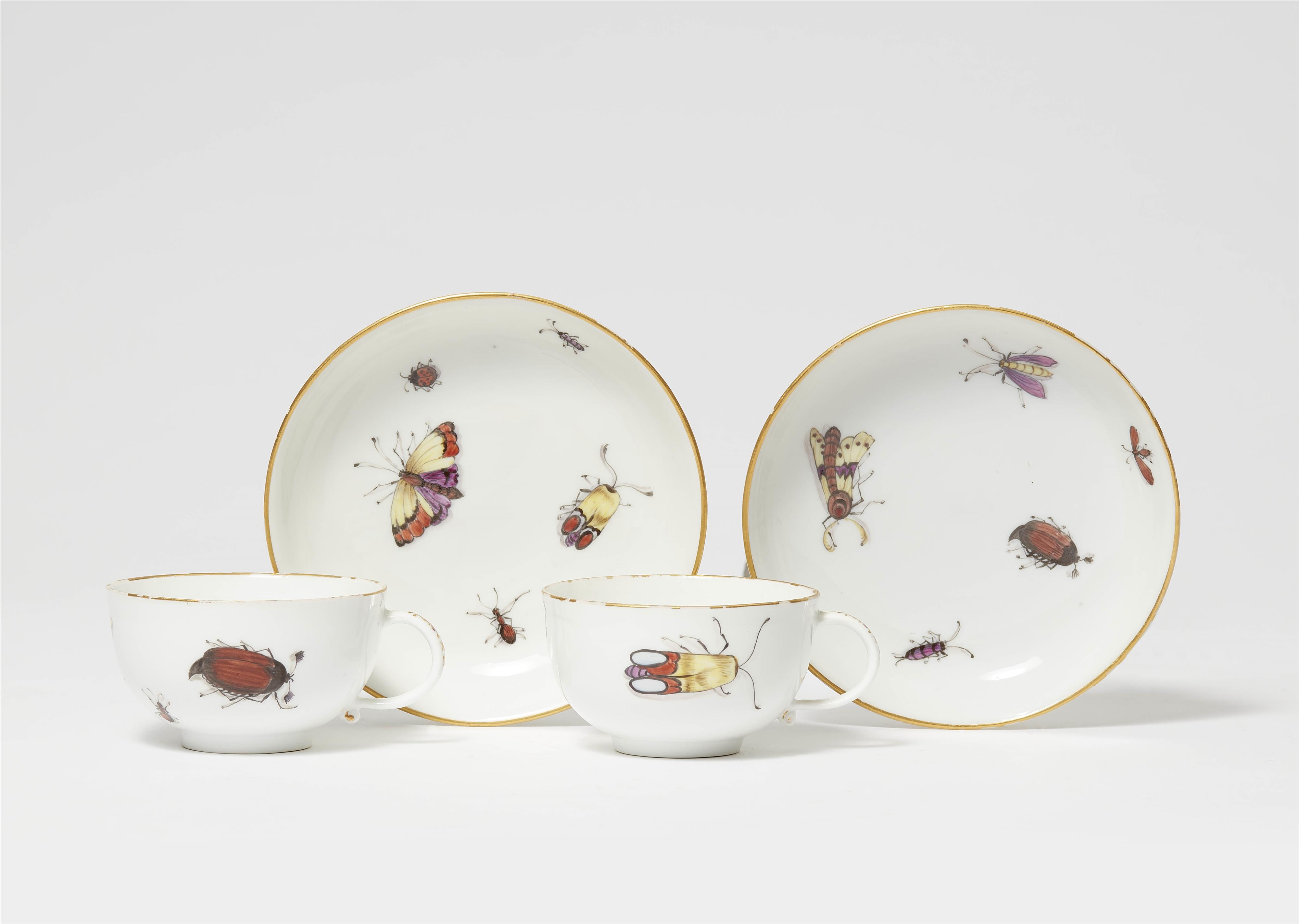 A pair of Meissen porcelain cups and saucers with insect decor - image-1