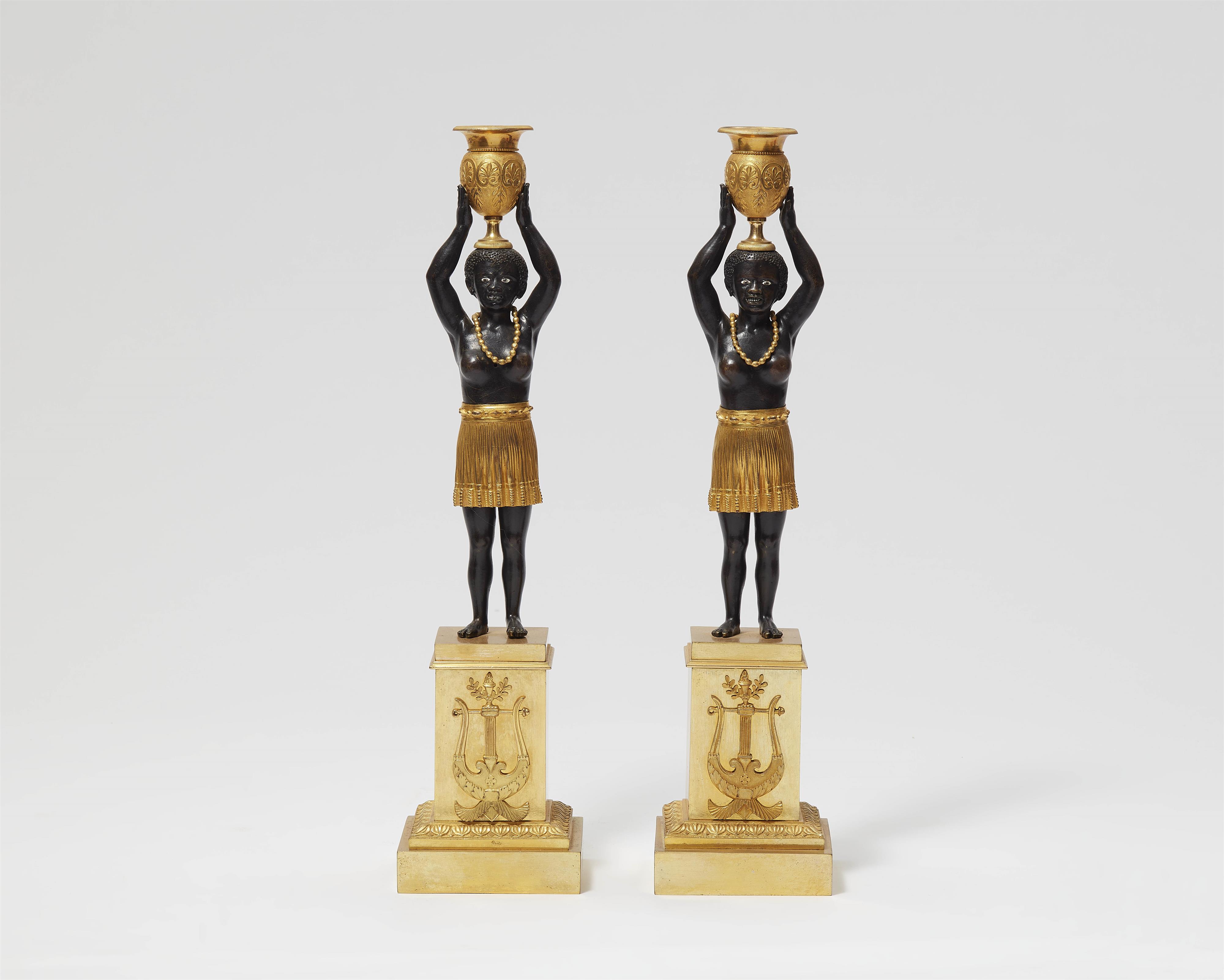 A pair of Empire ormolu candlesticks - image-1