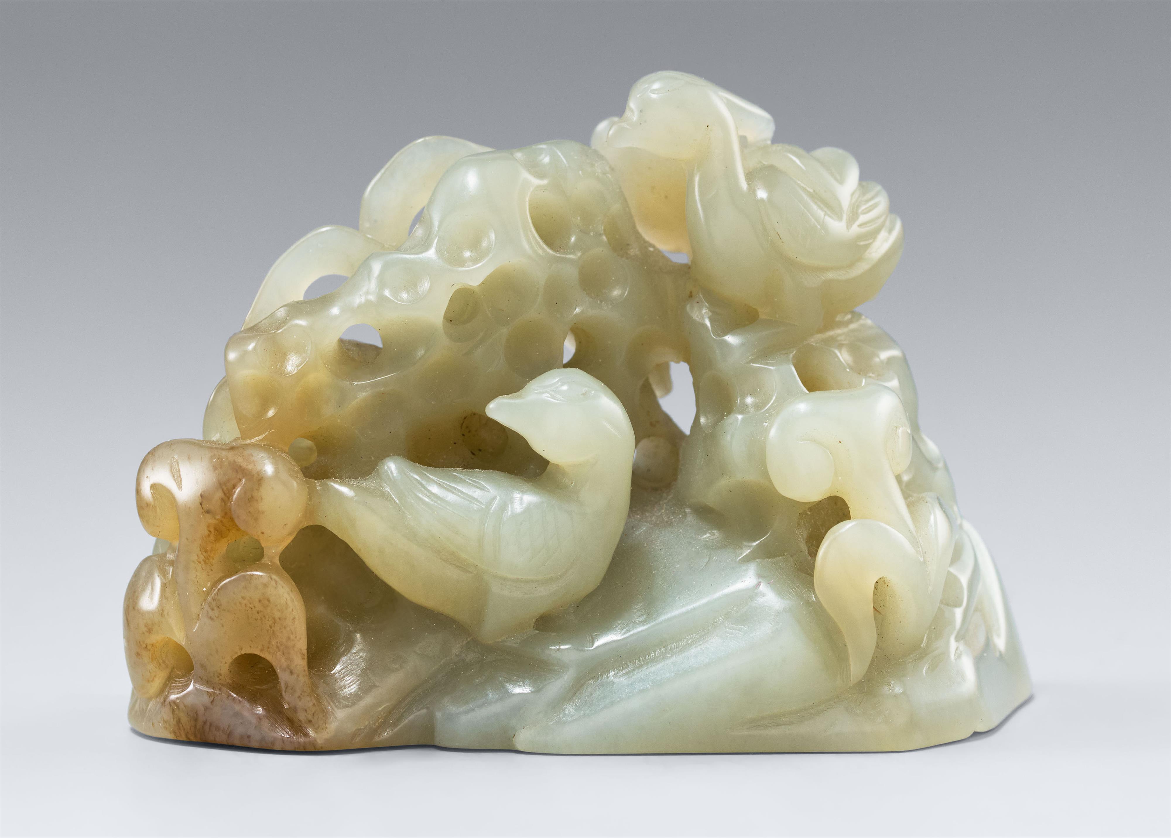 A light greyish green jade openwork carving of a pair of mandarin ducks. 19th/20th century - image-1