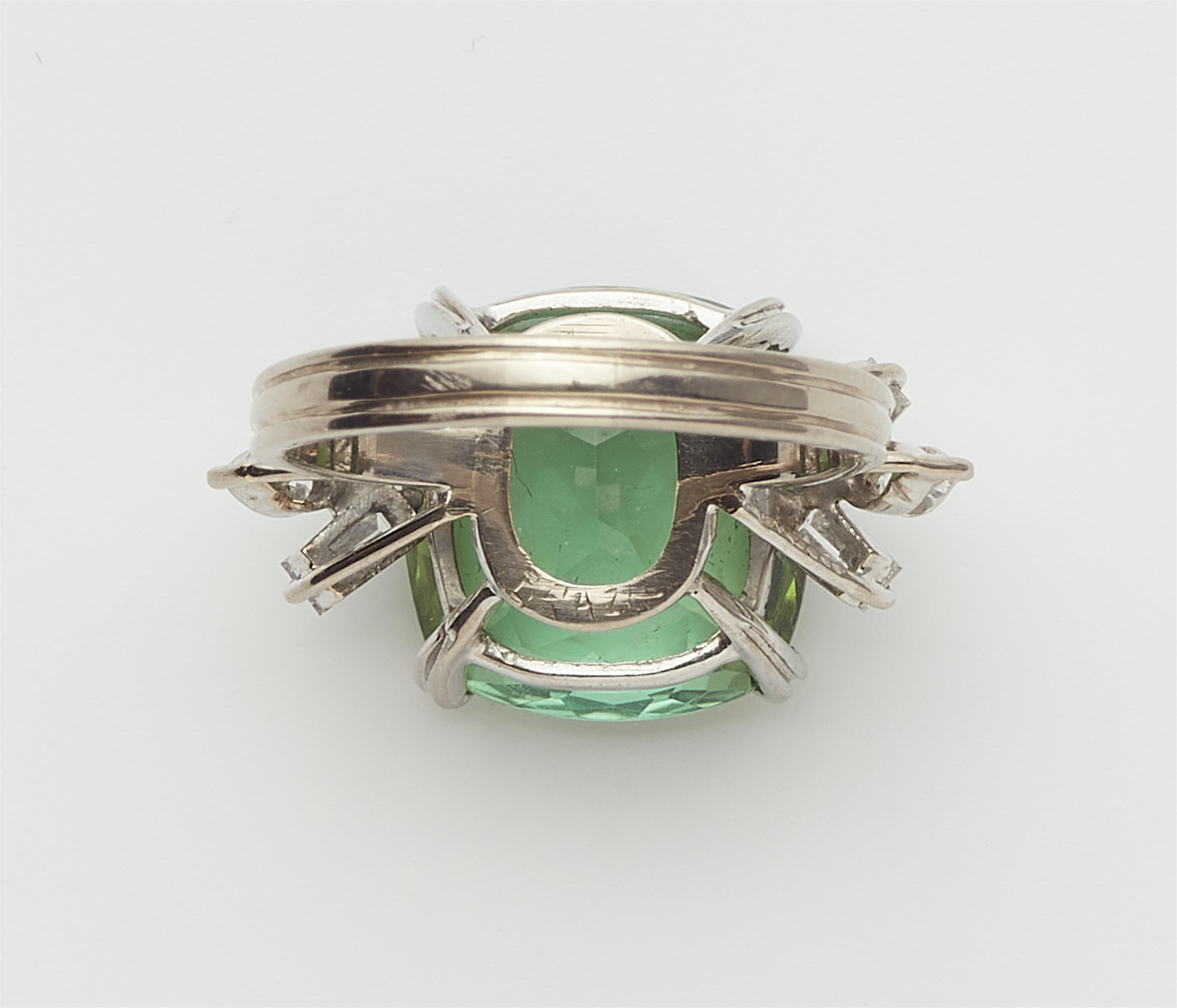 An 18k gold diamond and green tourmaline ring. - image-3