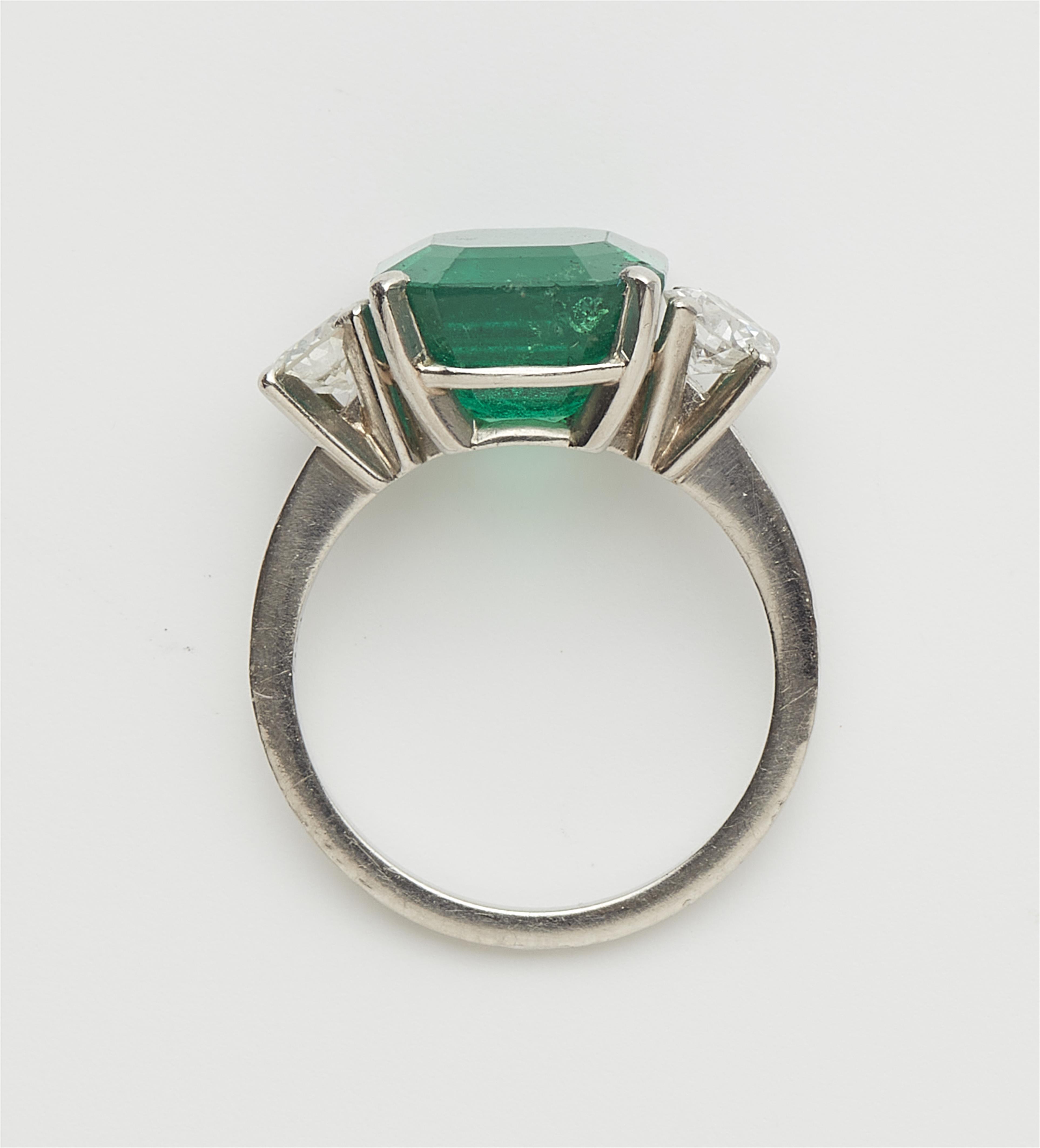A Columbian platinum emerald and diamond three stone ring. - image-2