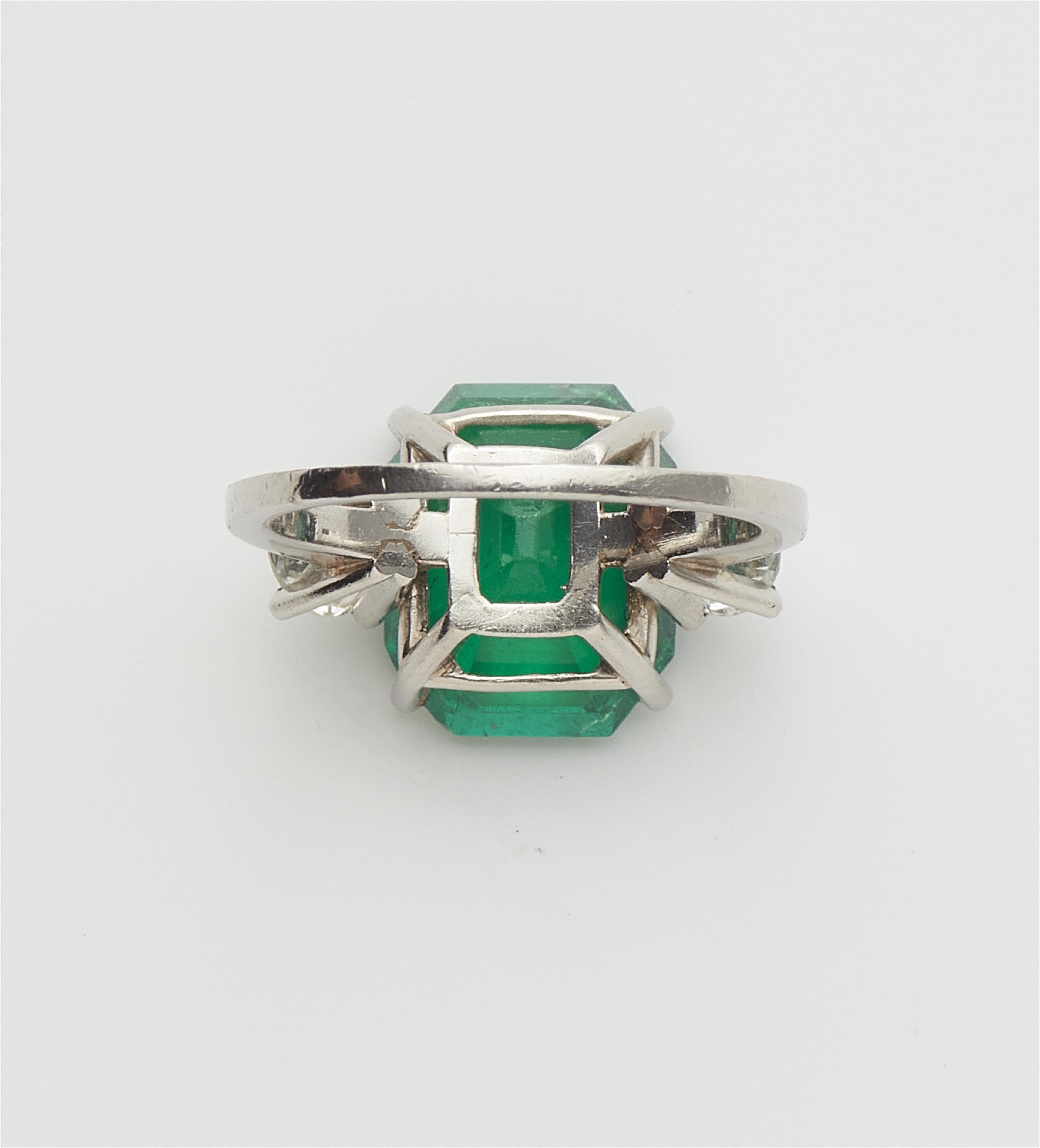 A Columbian platinum emerald and diamond three stone ring. - image-3