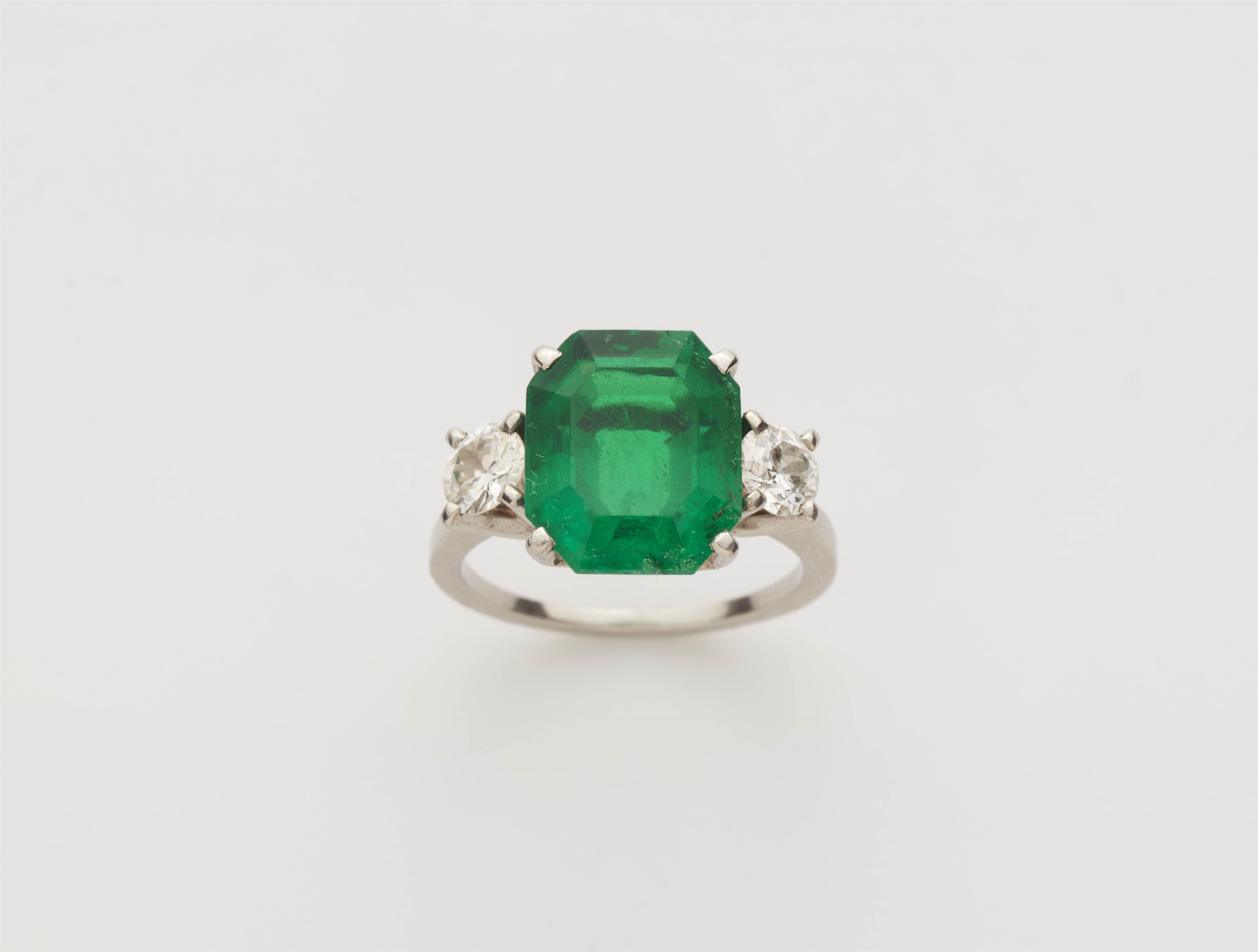 A Columbian platinum emerald and diamond three stone ring. - image-1