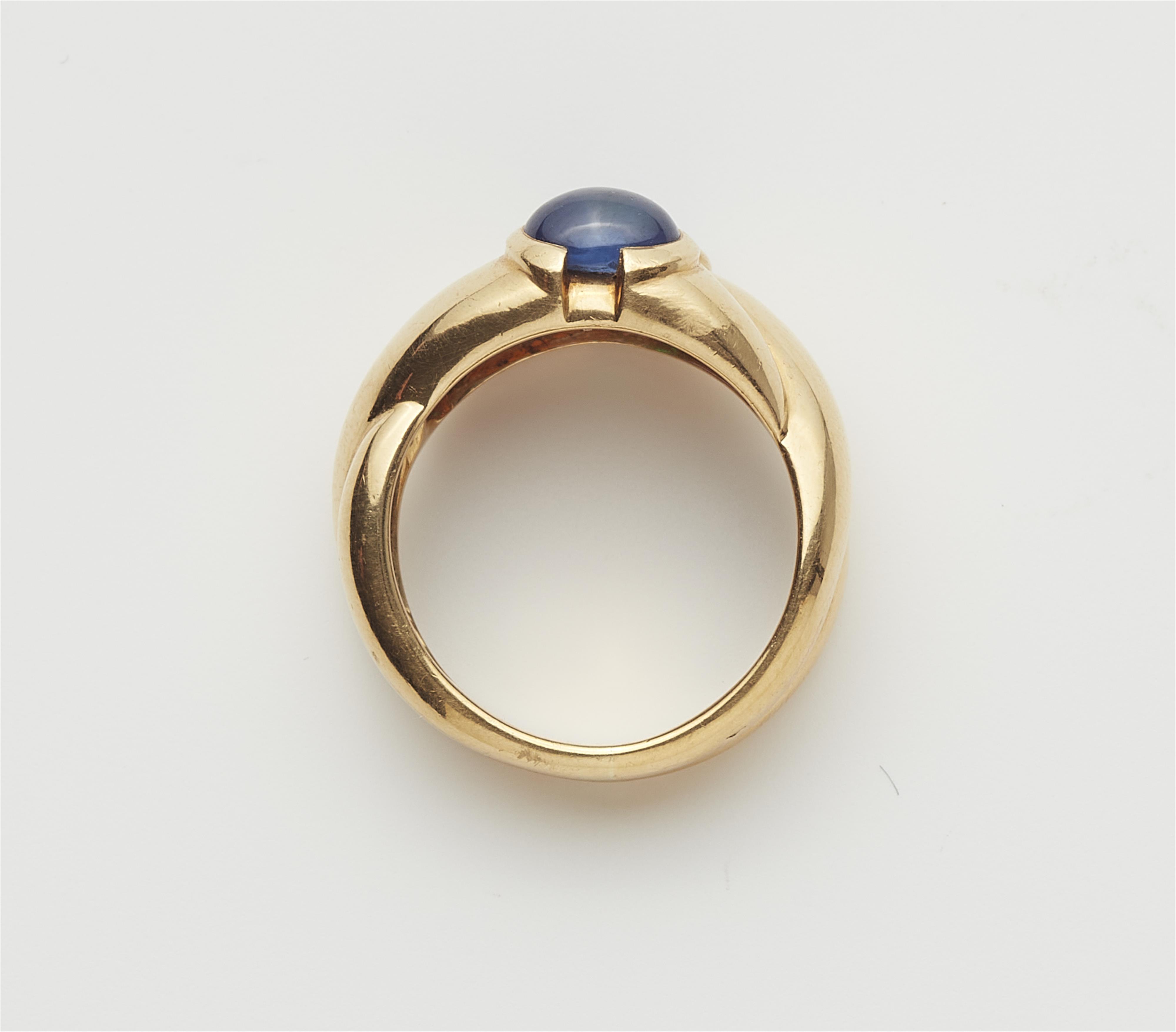 An 18k gold sapphire and emerald cabochon band ring. - image-2