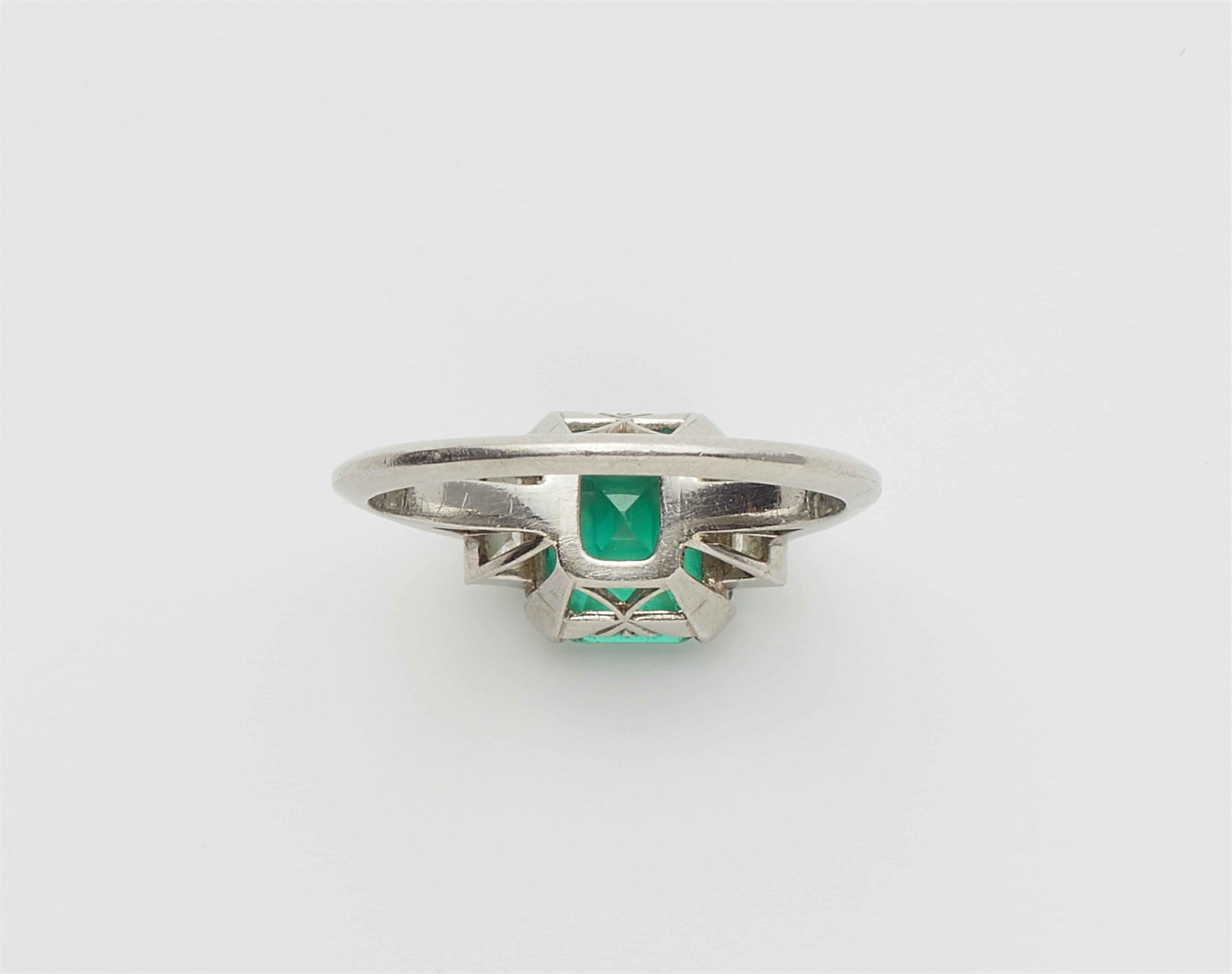A platinum diamond and fine Columbian emerald ring. - image-3