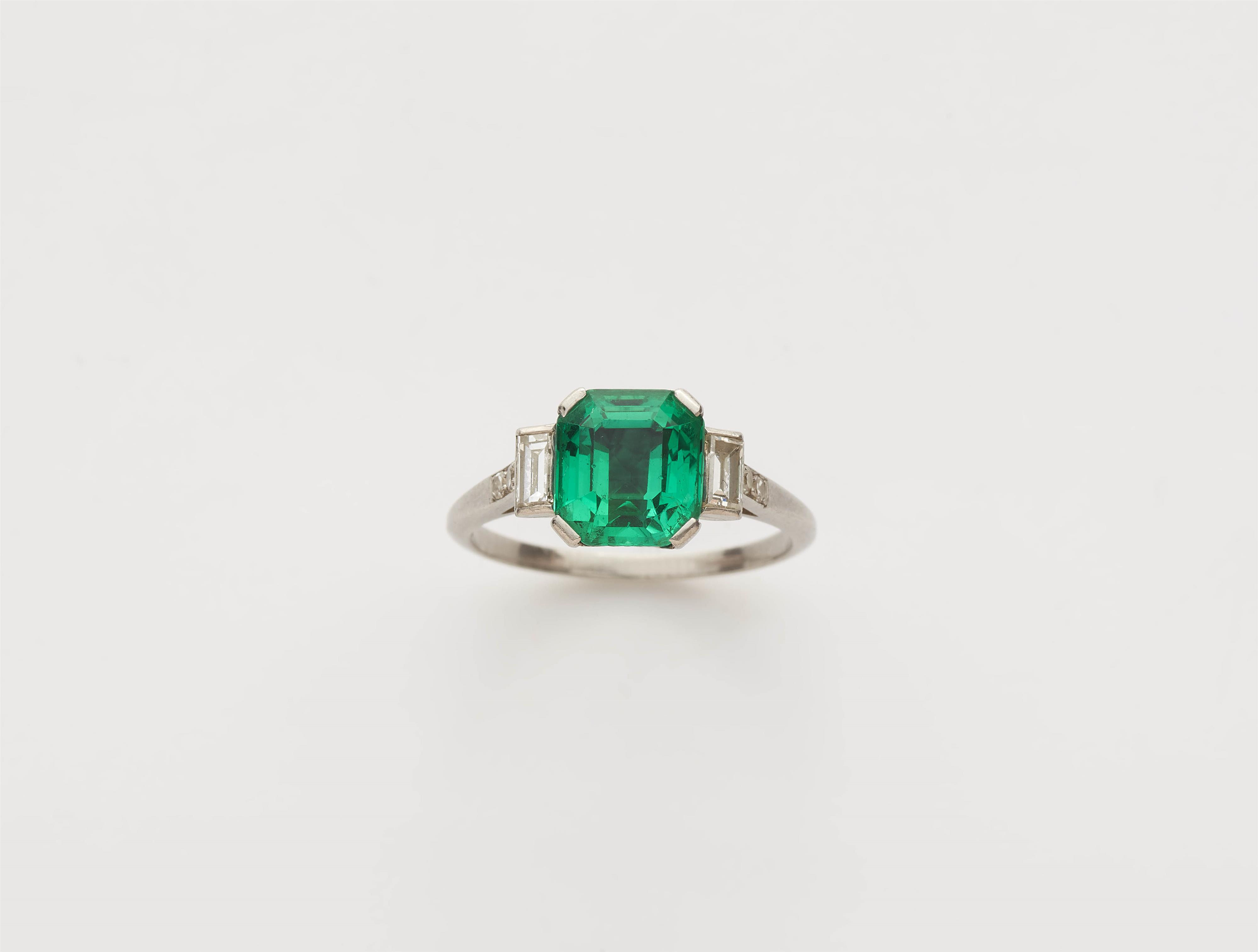 A platinum diamond and fine Columbian emerald ring. - image-1