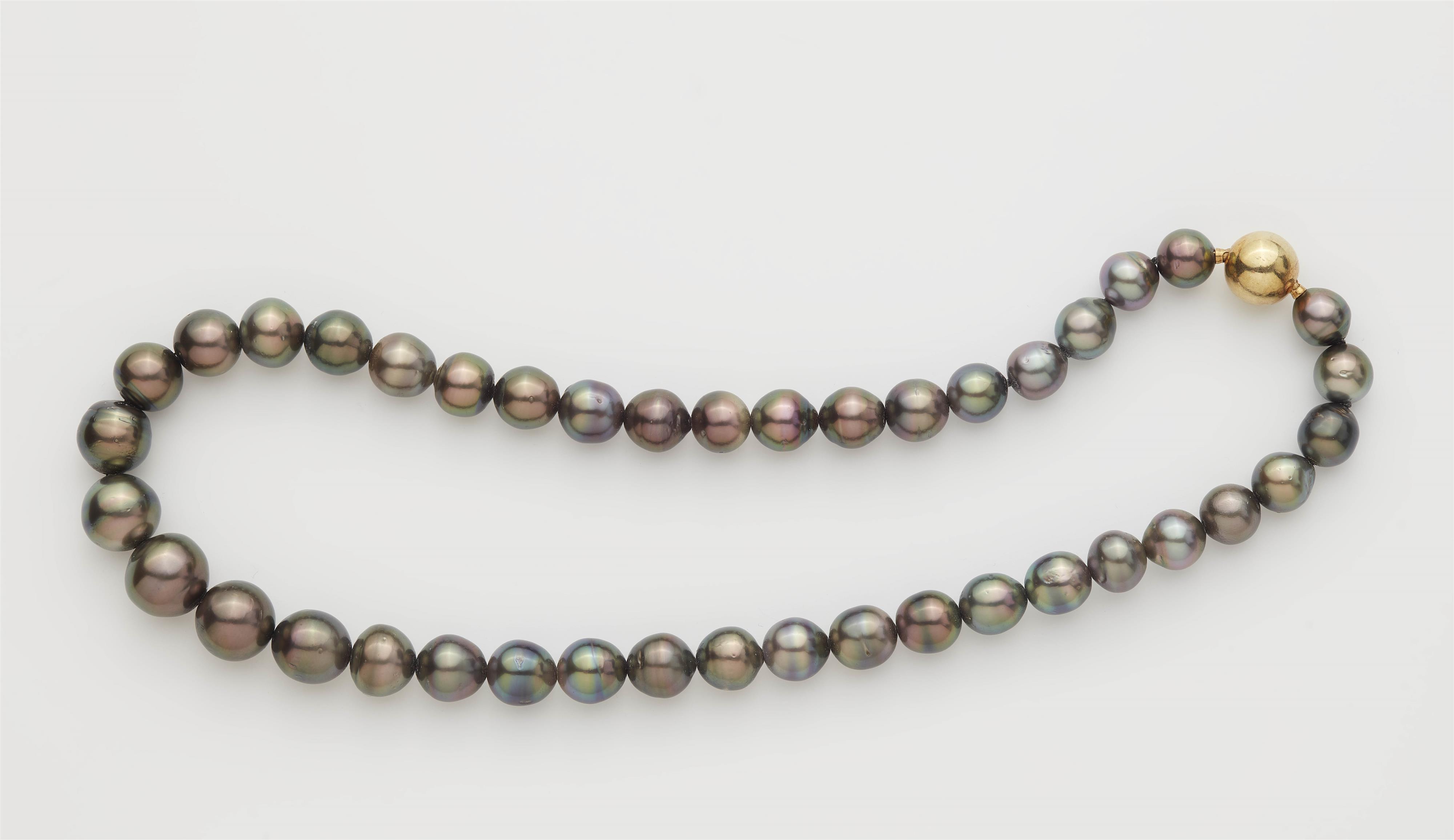 An 18k gold Tahiti pearl necklace. - image-1