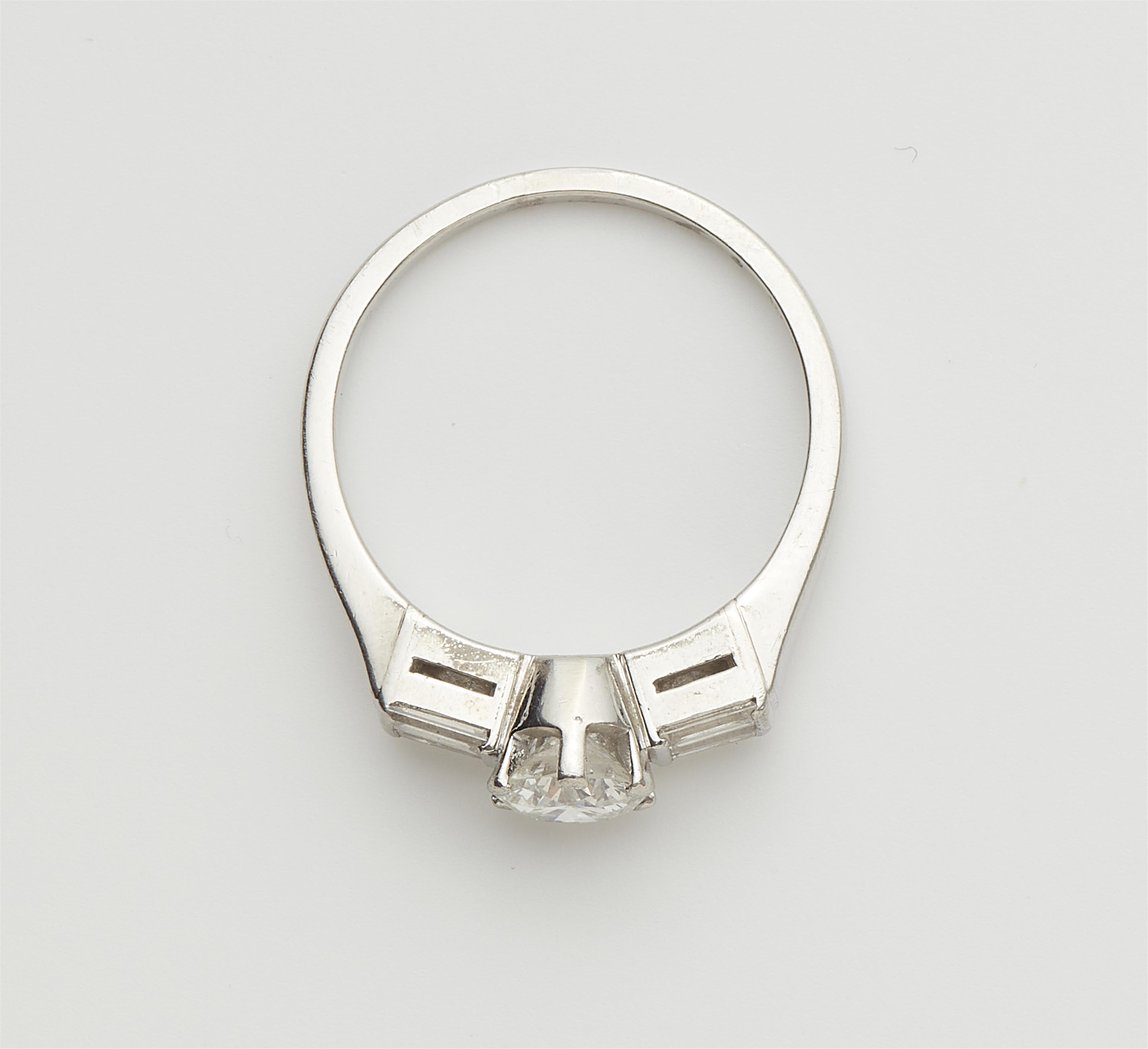 A platinum diamond solitaire ring. - image-2