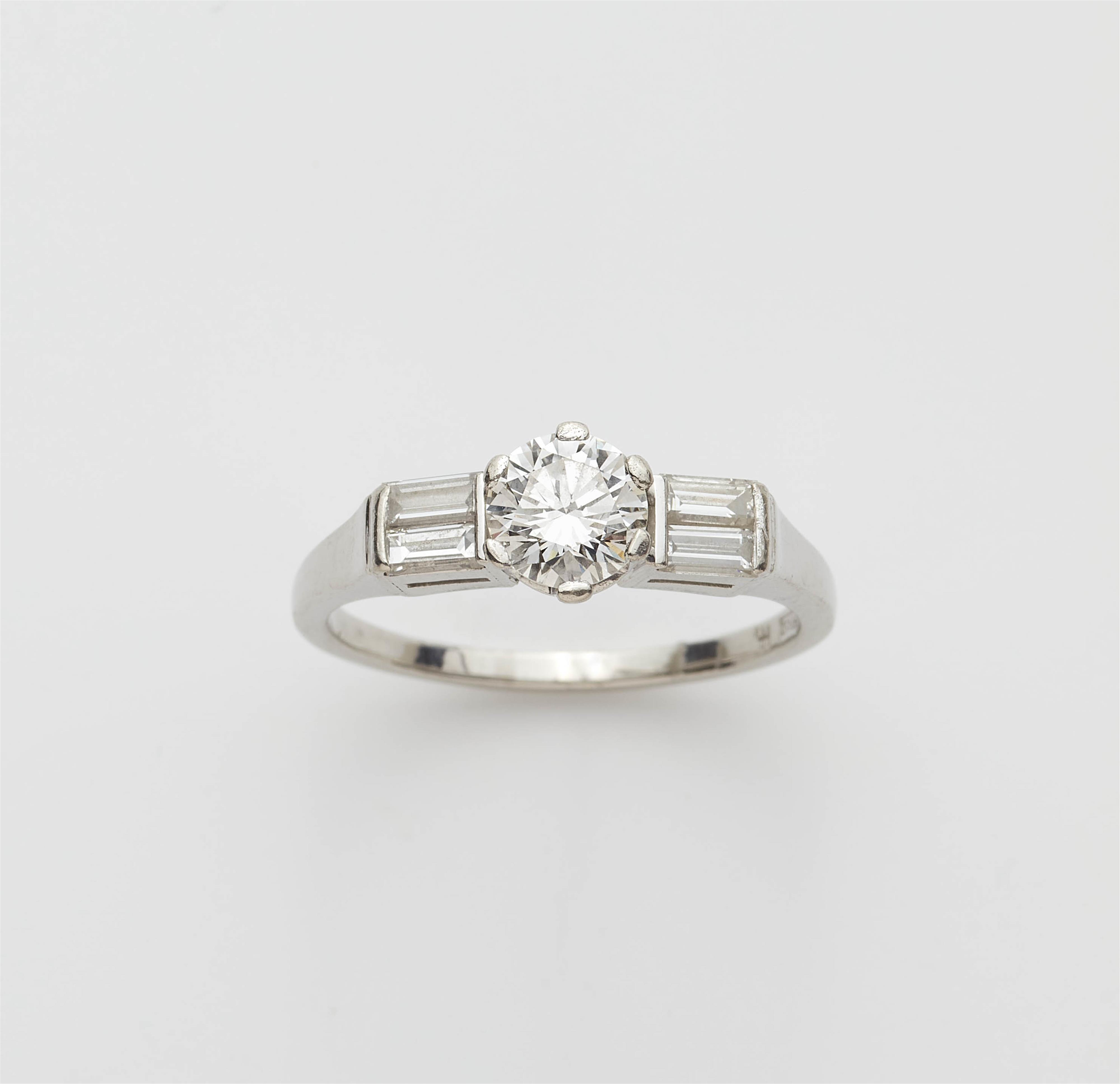 A platinum diamond solitaire ring. - image-1