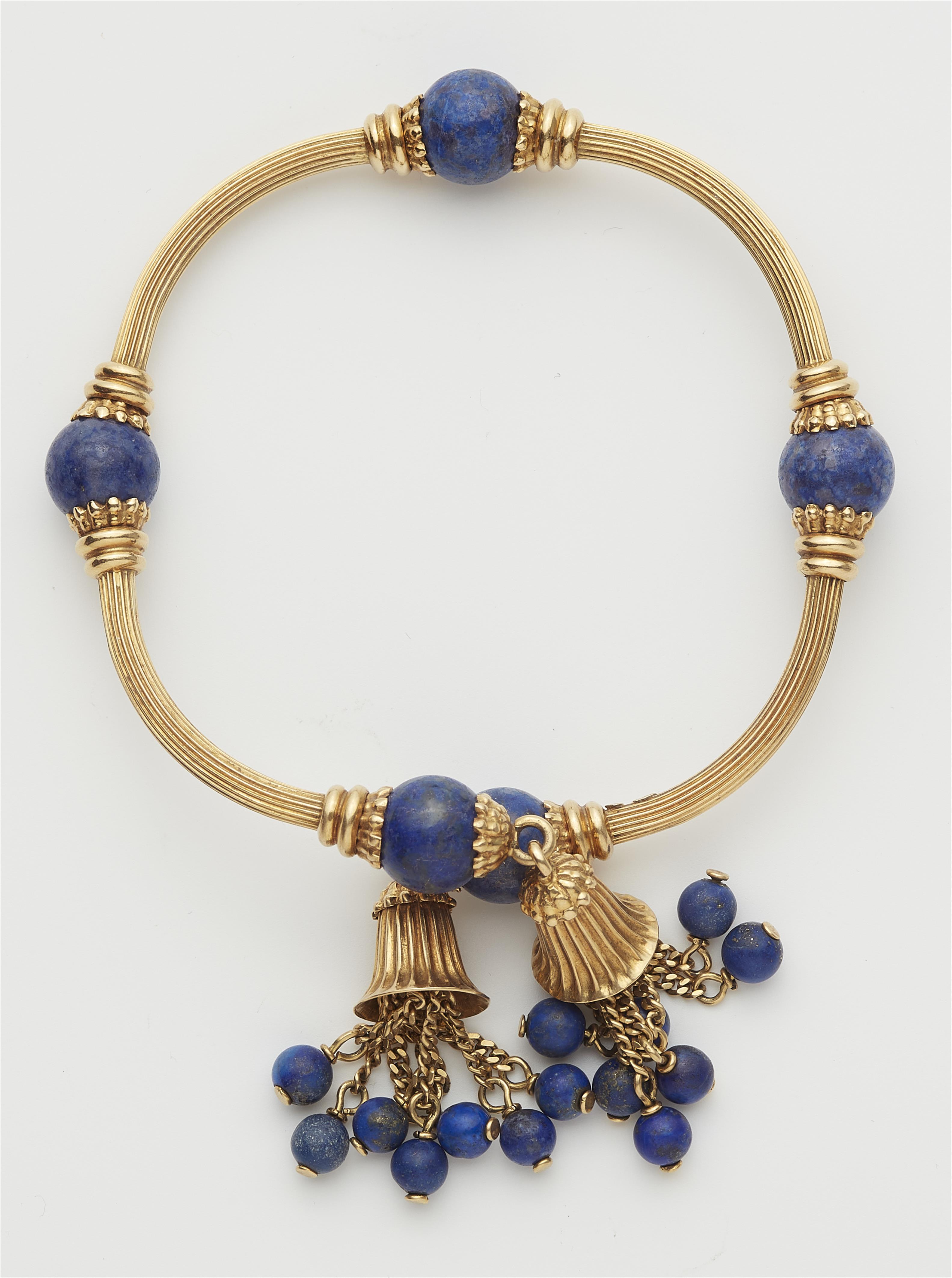 An archeological revival 18k gold and lapis lazuli bangle with tassels. - image-2