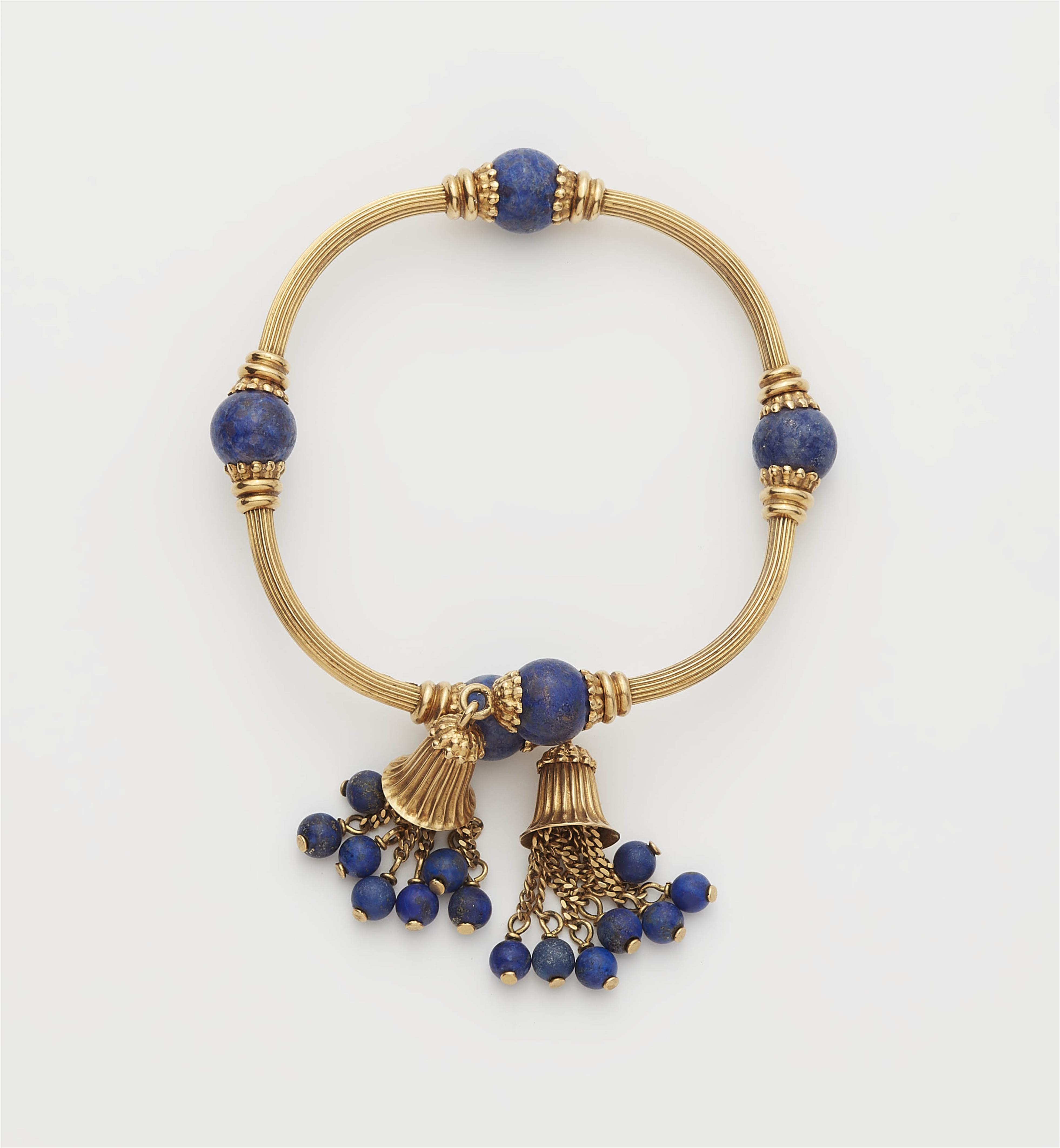 An archeological revival 18k gold and lapis lazuli bangle with tassels. - image-1