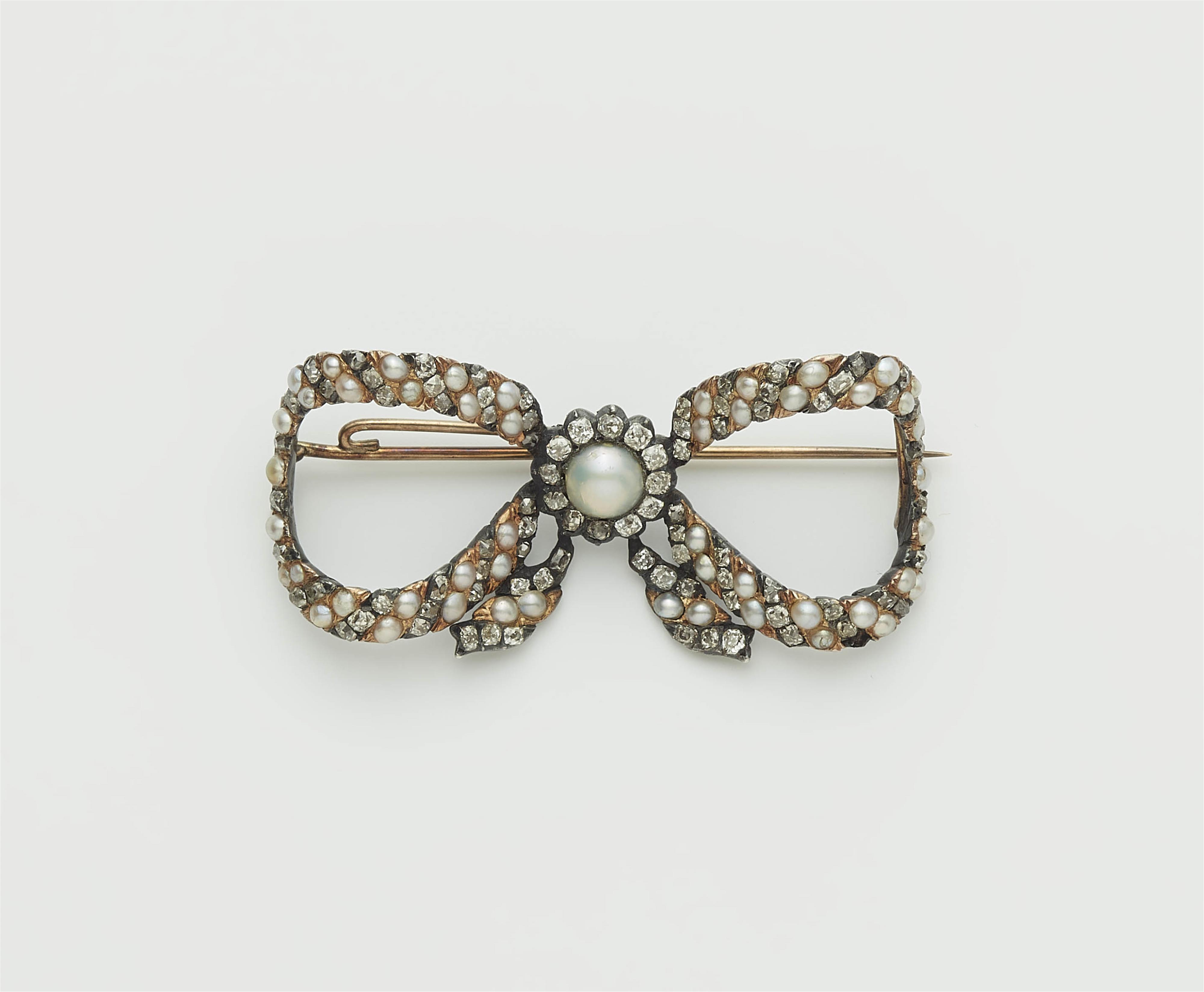 An early 19th century silver gilt pearl and cushion-cut diamond bow brooch with 14k gold mount. - image-1