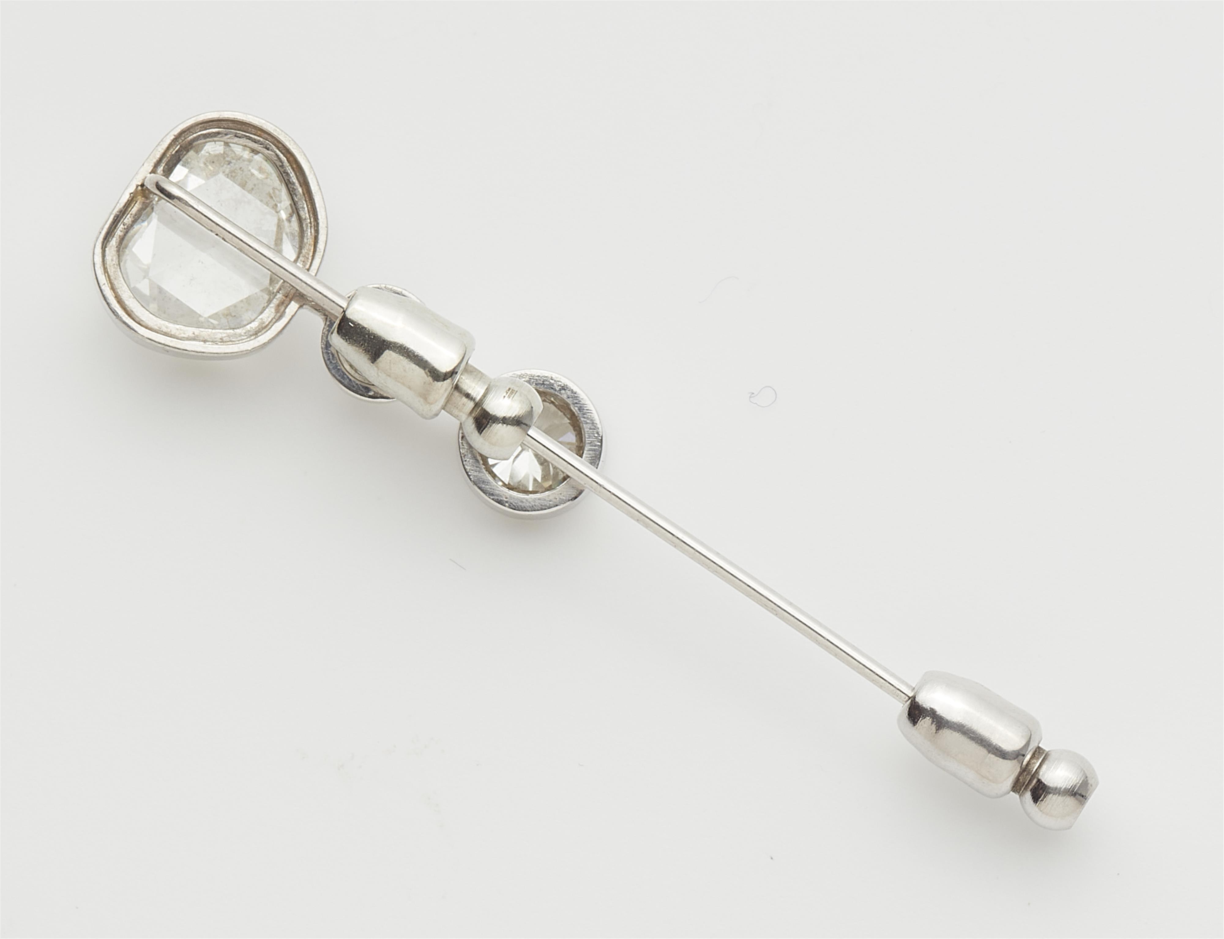An 18k white gold lapel pin with three old diamond solitaires. - image-2