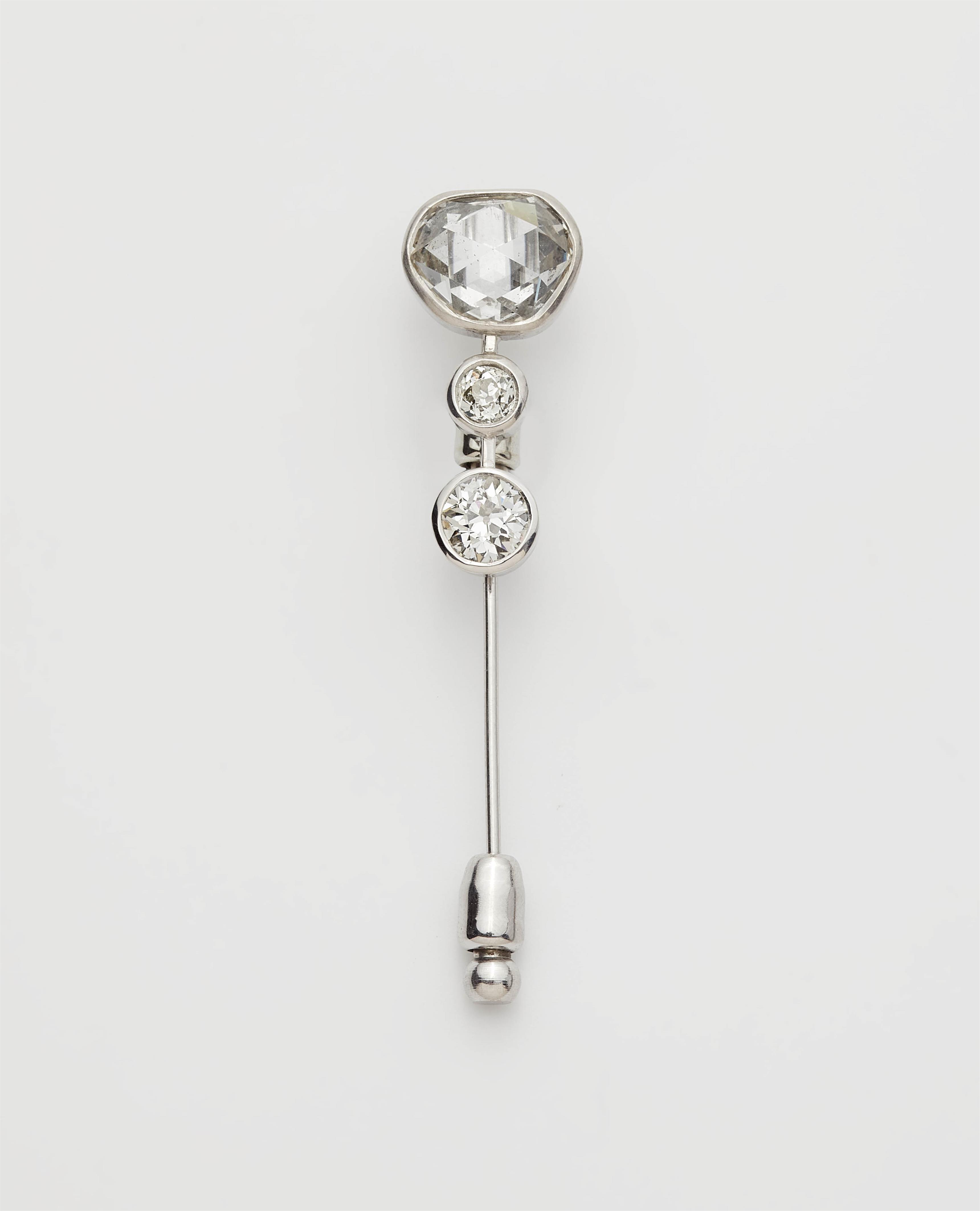 An 18k white gold lapel pin with three old diamond solitaires. - image-1