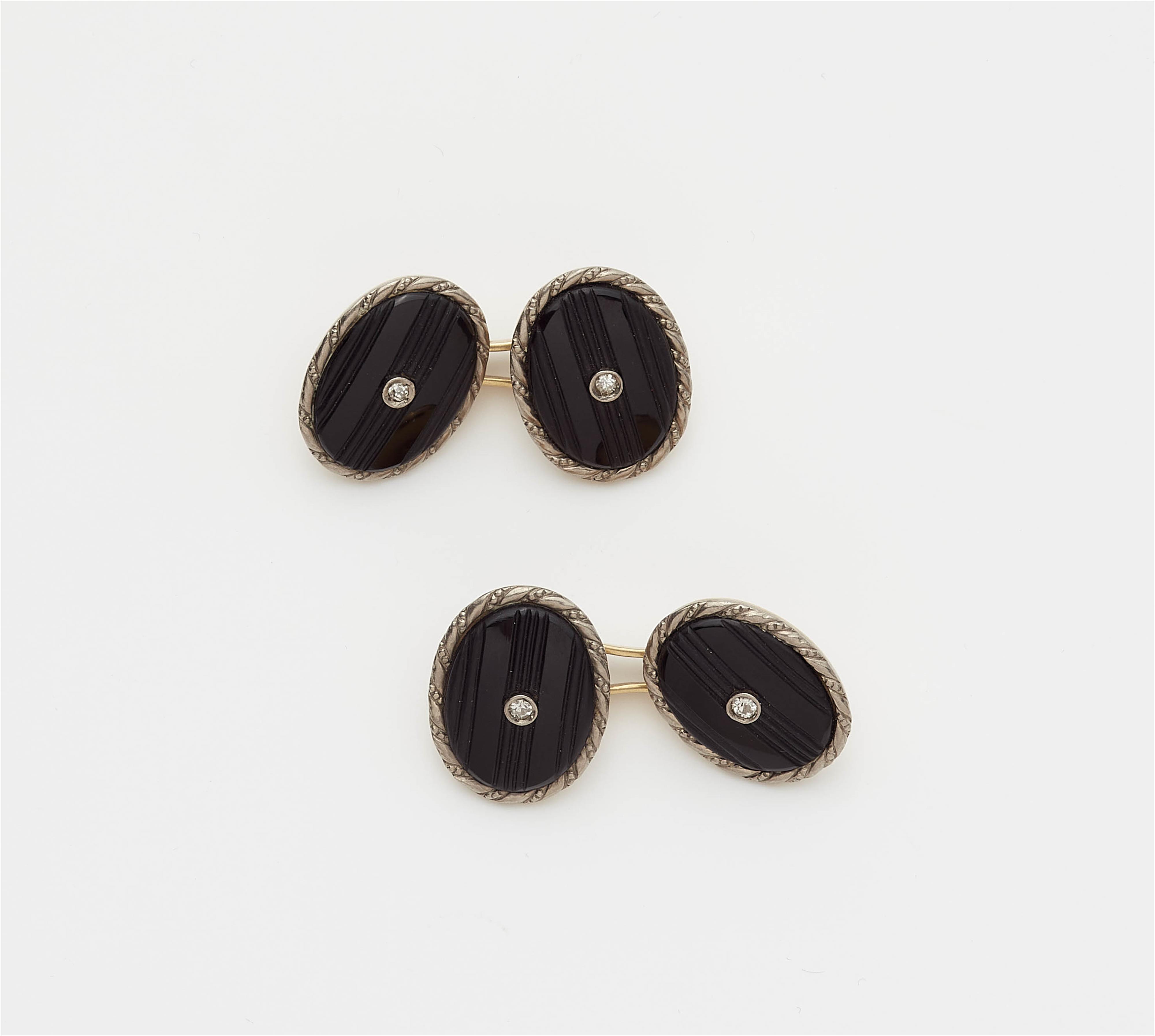 A pair of 14k gold diamond and carved onyx cufflinks. - image-1
