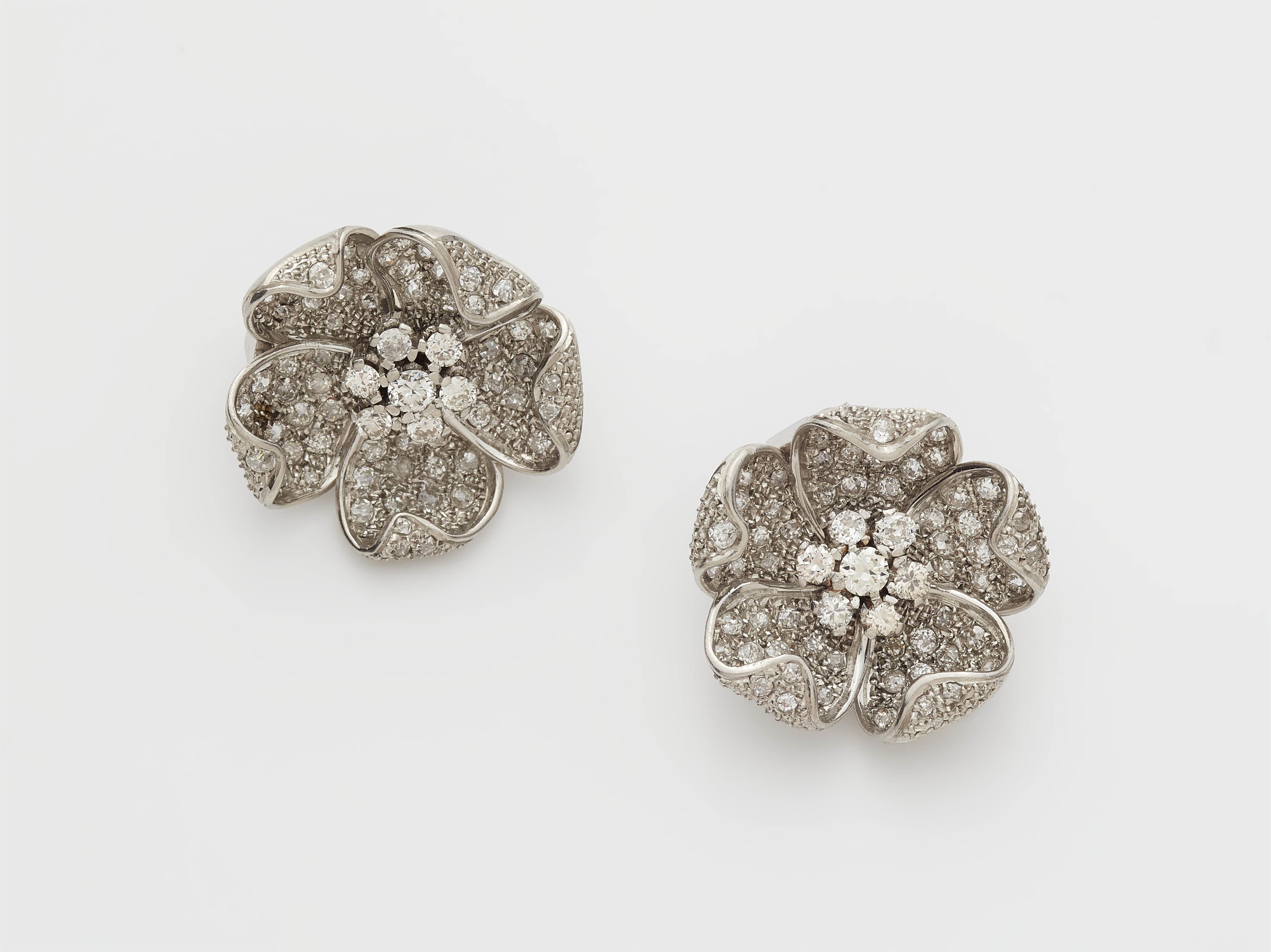 A pair of Retro style 18k white gold and diamond flower clips. - image-1