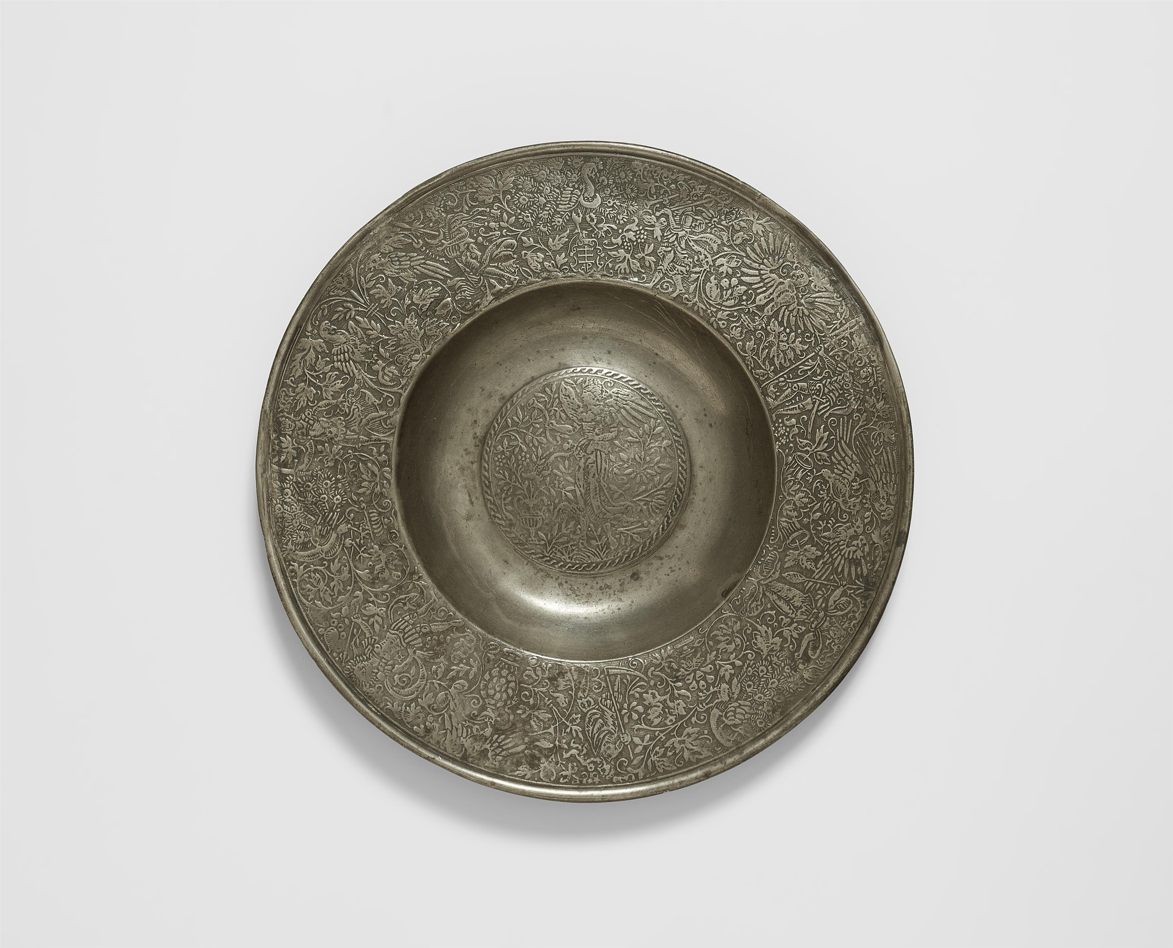 A broad rimmed pewter plate with a figure of Fama - image-1