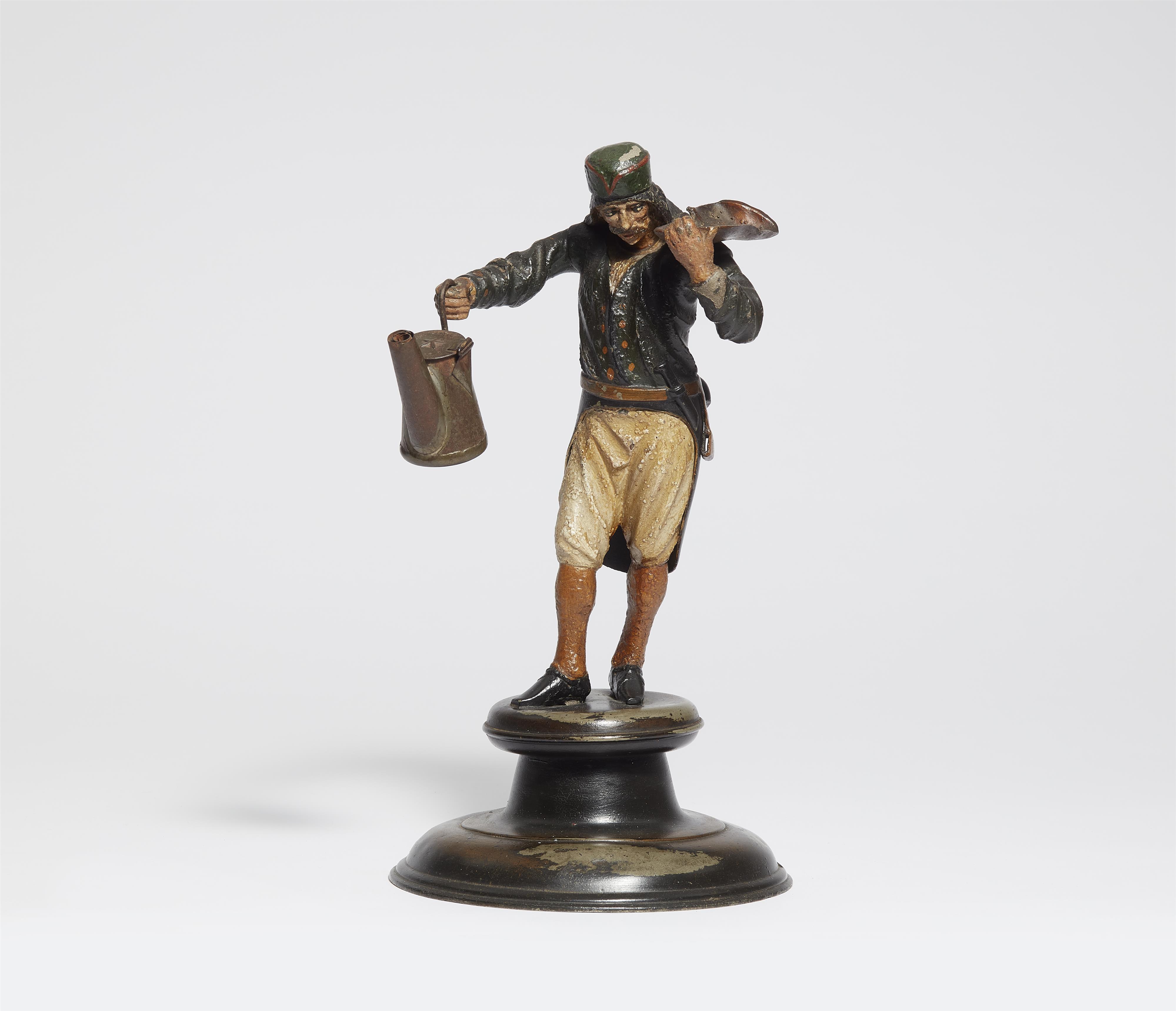 A pewter figure of a miner with an oil lamp - image-1
