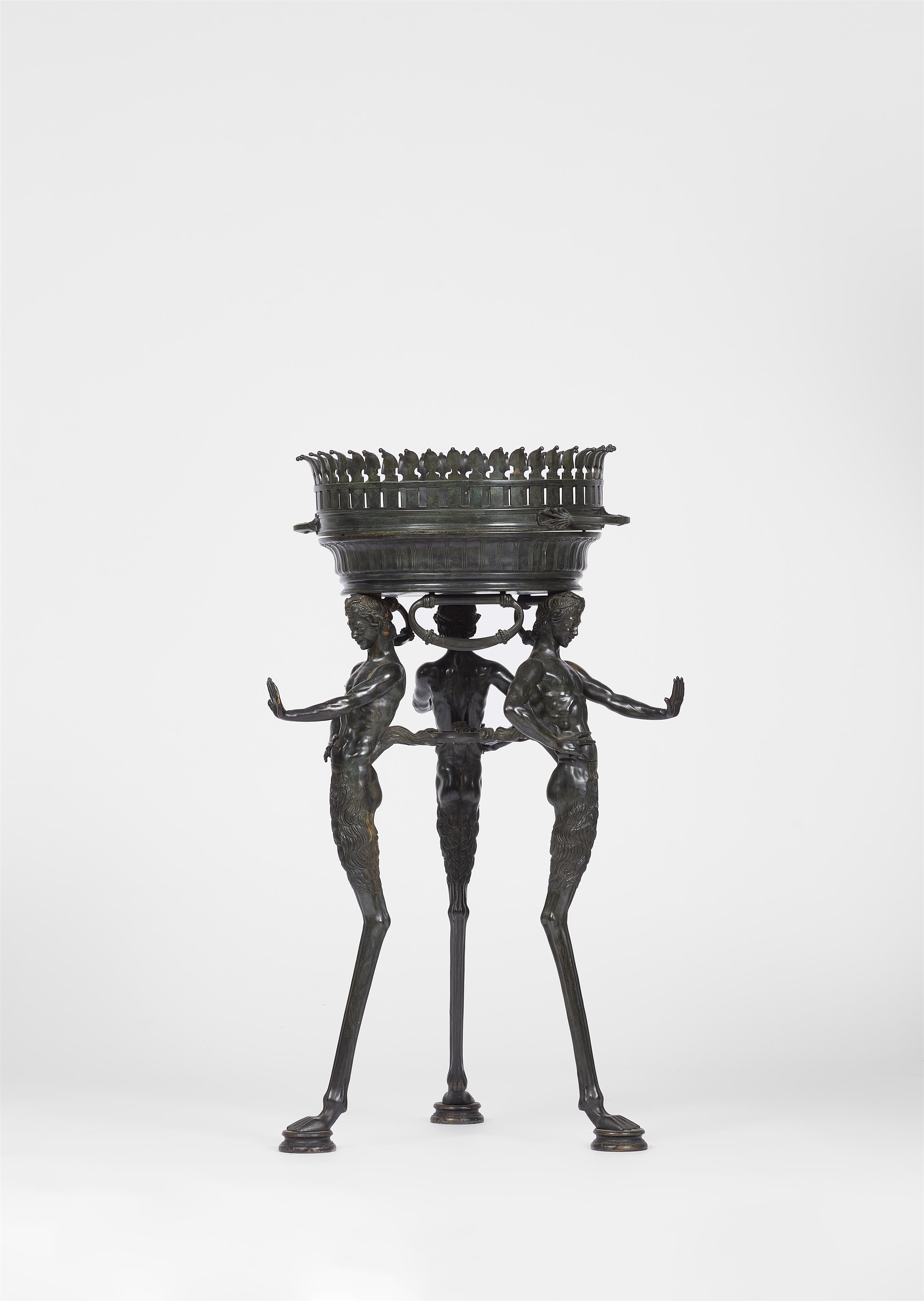 A patinated bronze tripod with three male figures - image-1