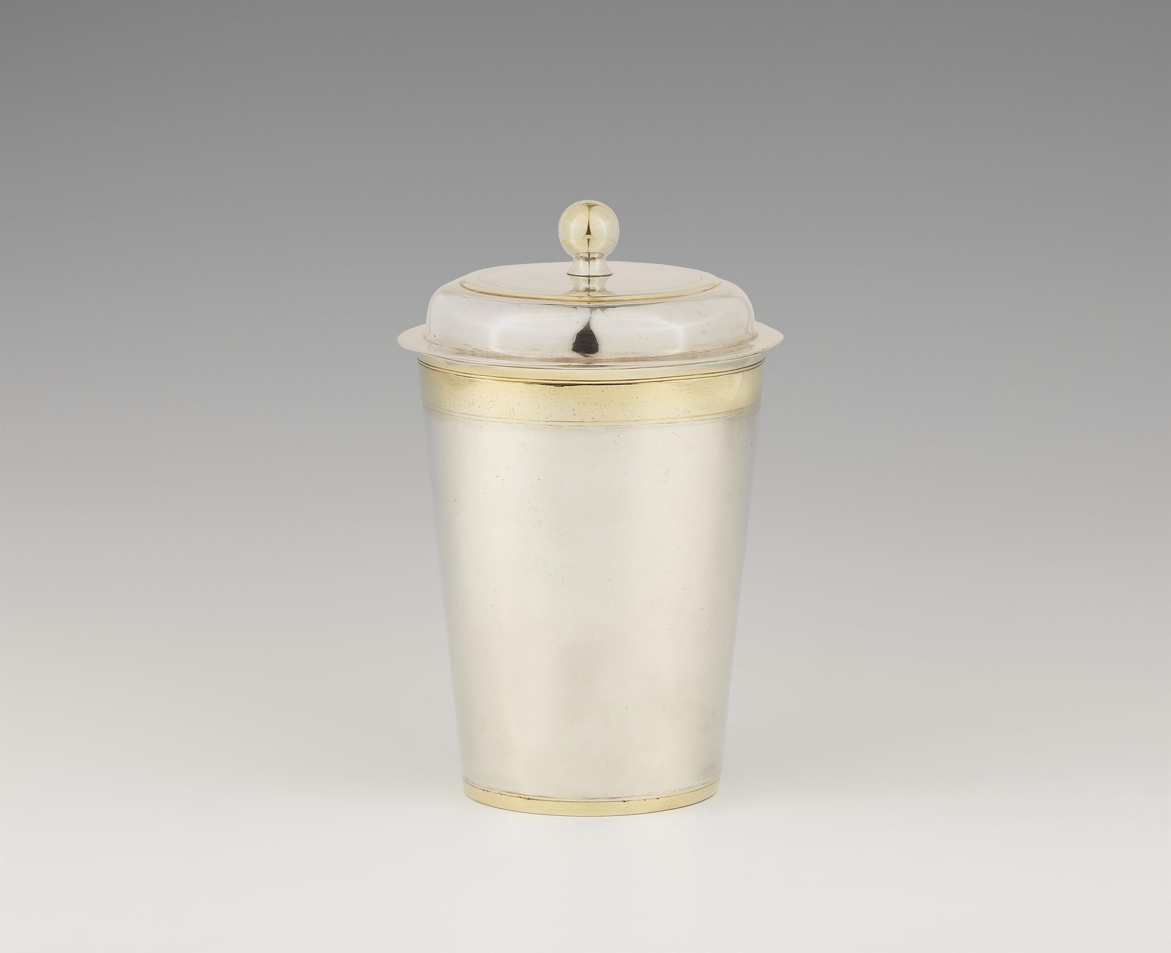 A parcel gilt Tilsit silver beaker and cover - image-1
