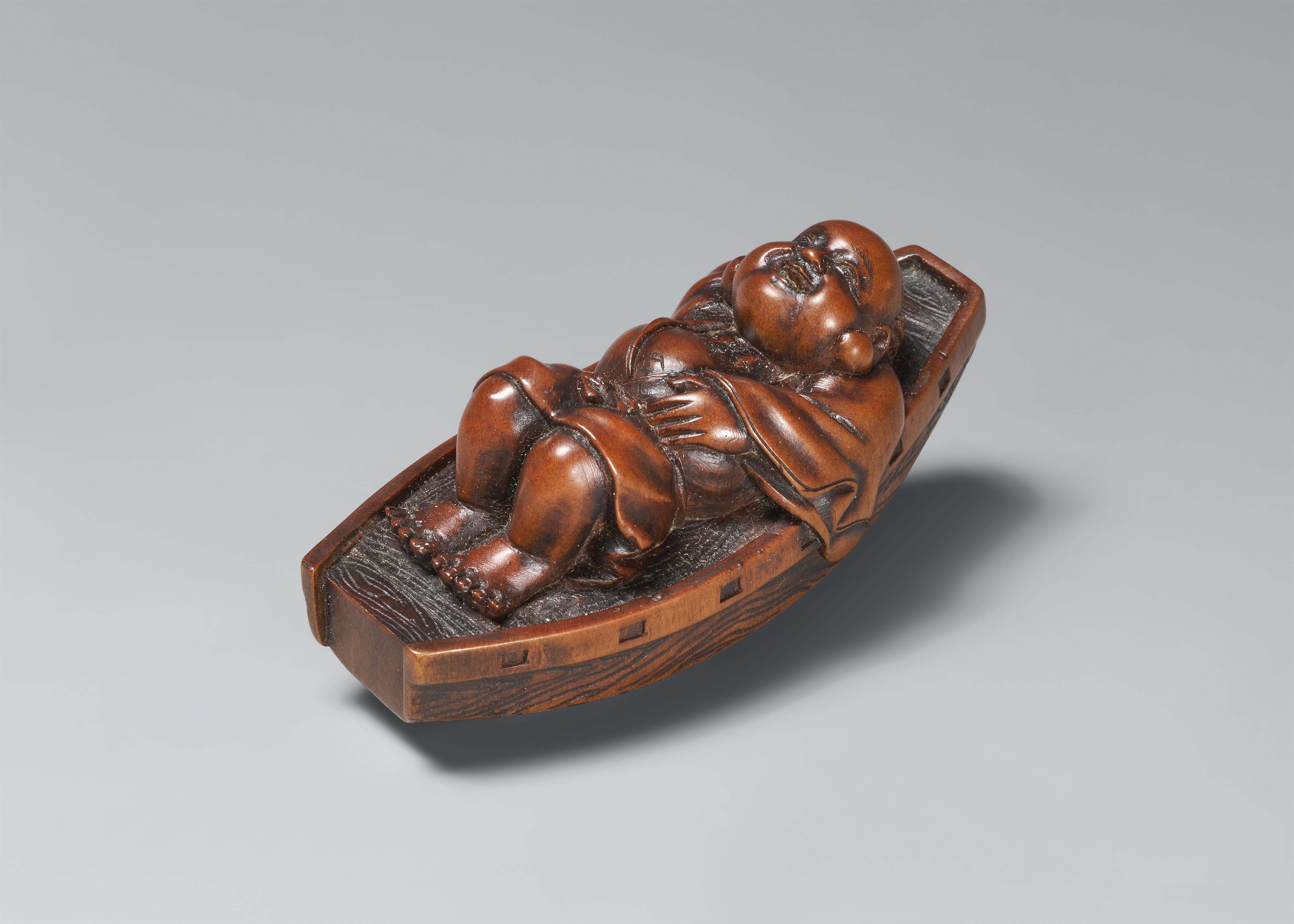 A boxwood netsuke of Hotei resting in a boat. Late 19th century - image-1