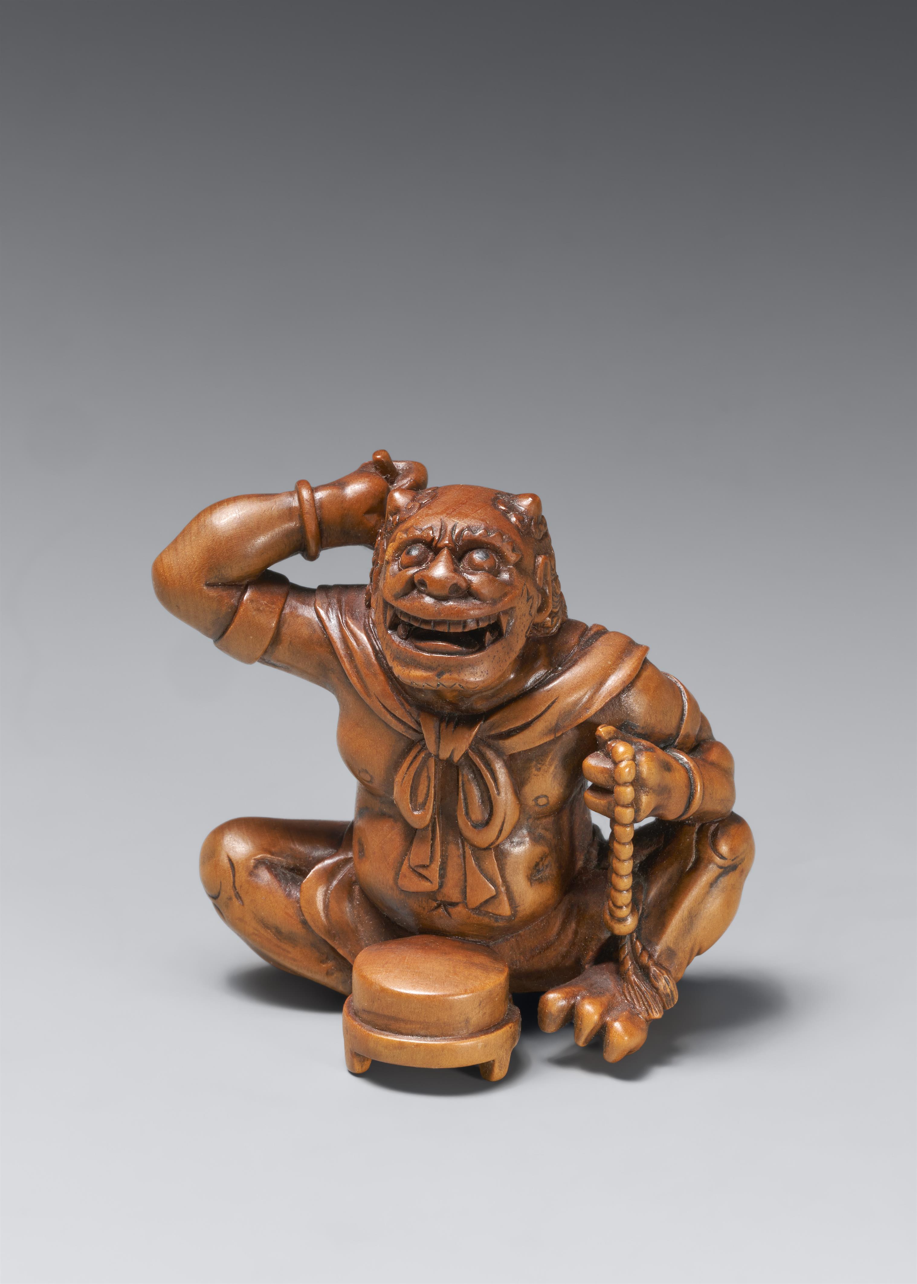 A large boxwood okimono netsuke of a laughing oni. Late 19th century - image-1