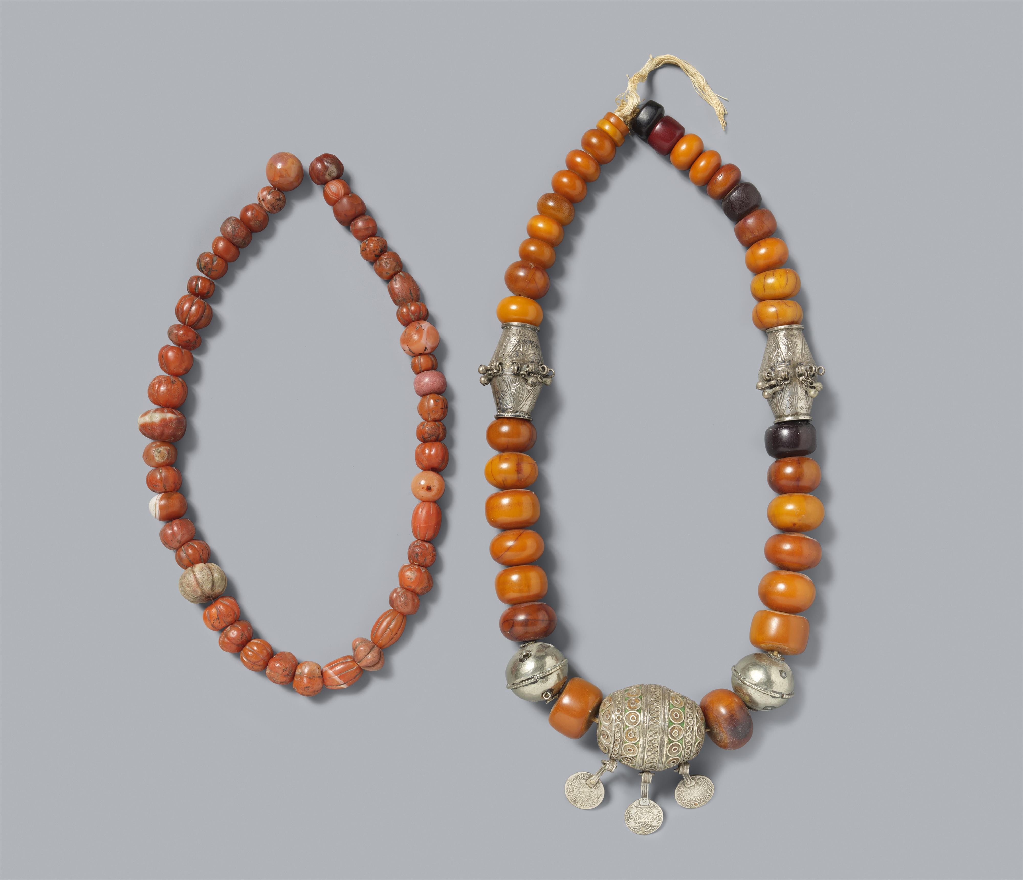 Two Tibetan amber and other resins, silver, and coral beads necklaces - image-1
