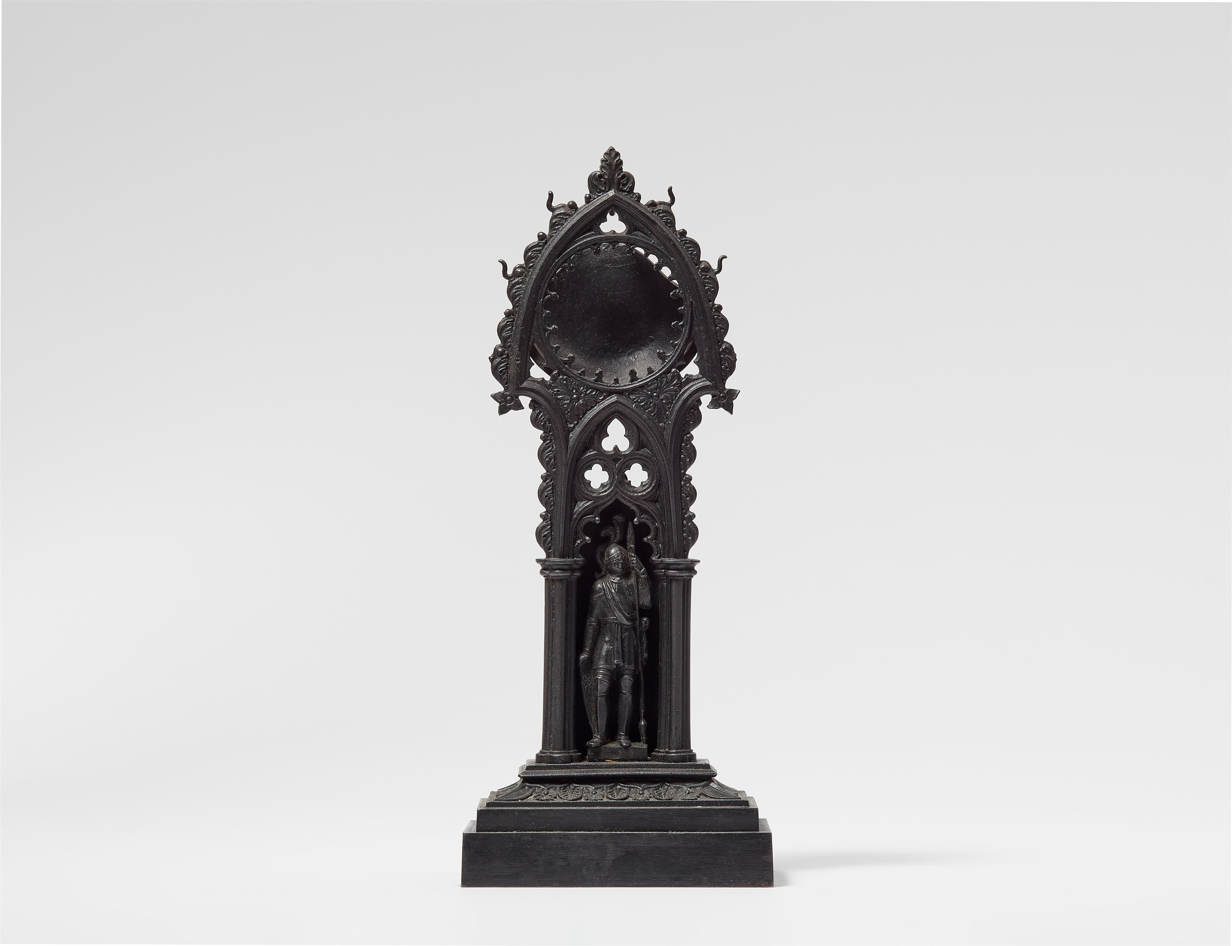 A cast iron porte montre with a figure of a knight - image-1