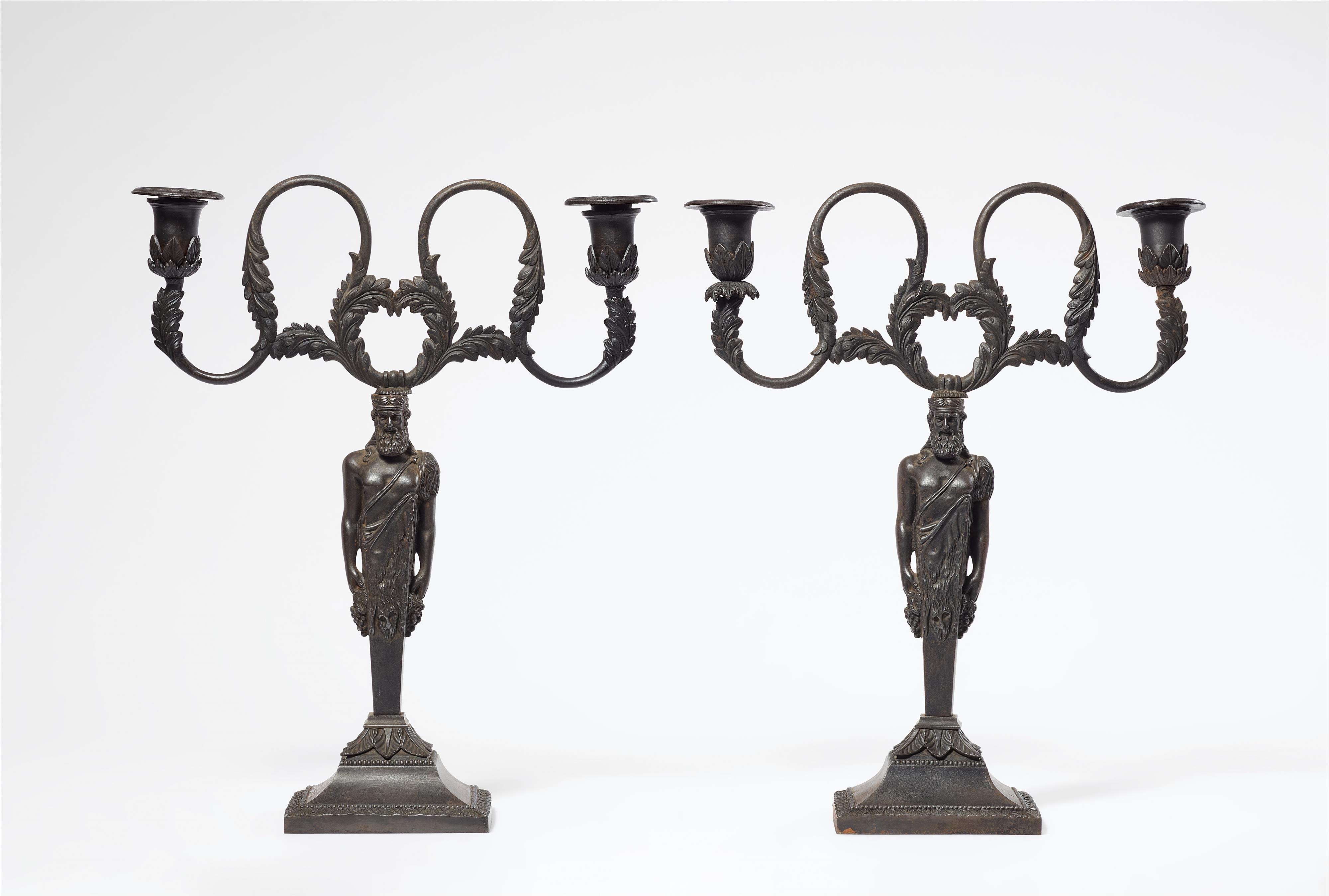 A rare pair of cast iron candlesticks formed as herms of Bacchus - image-1