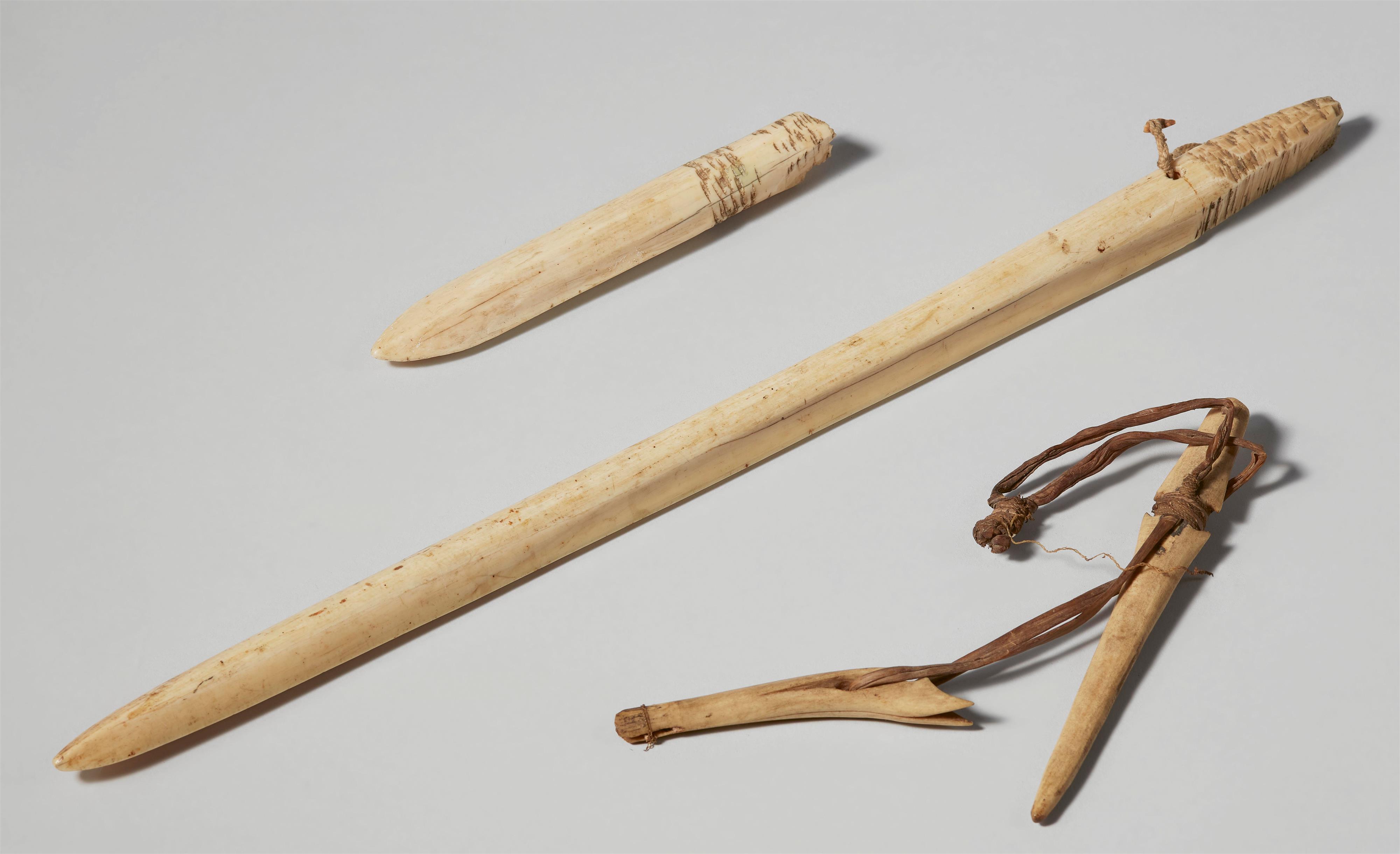 FIVE INUIT ARTEFACTS
Three harpoon points; a wood figure and a small ivory dog - image-2