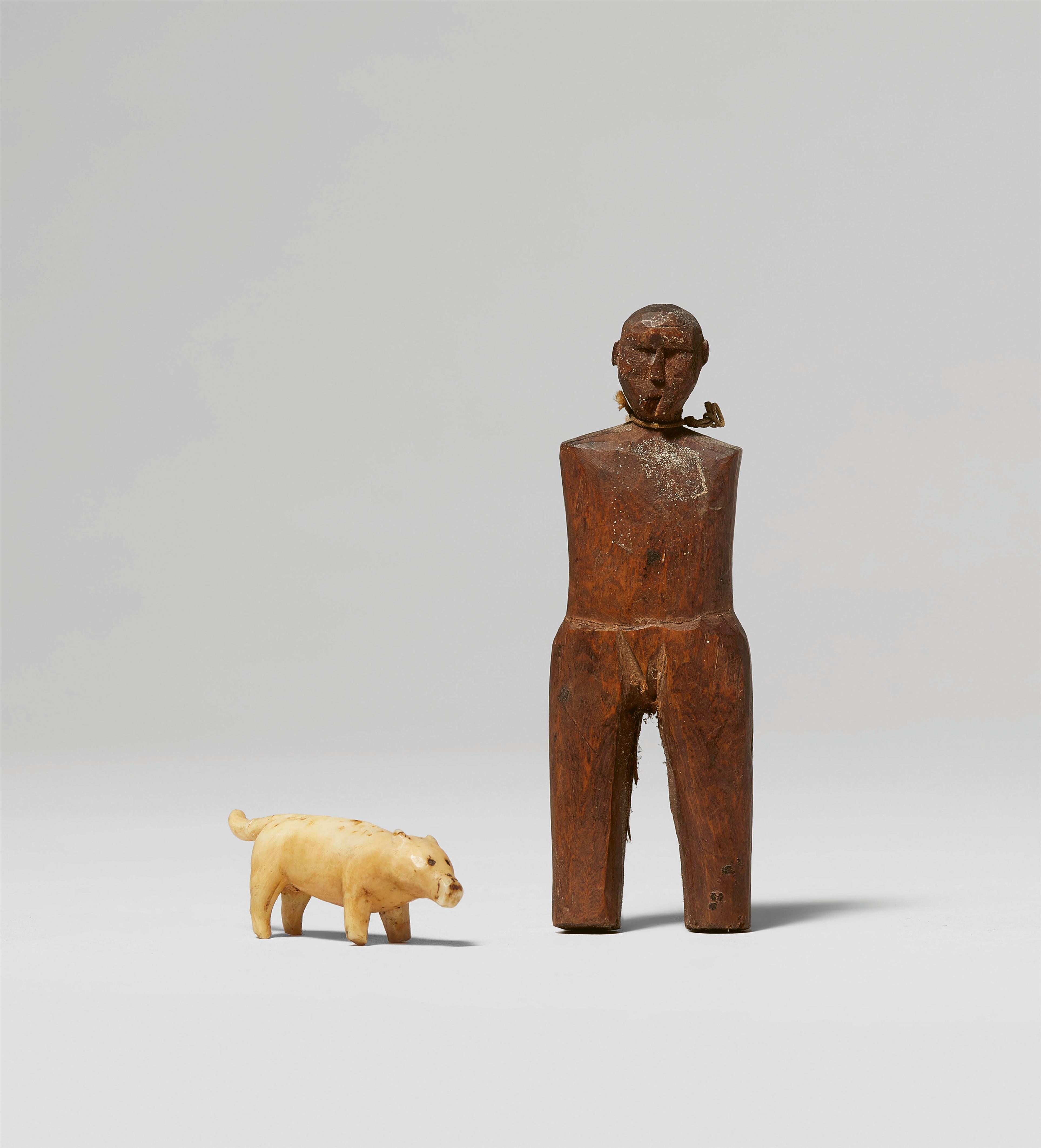 FIVE INUIT ARTEFACTS
Three harpoon points; a wood figure and a small ivory dog - image-1