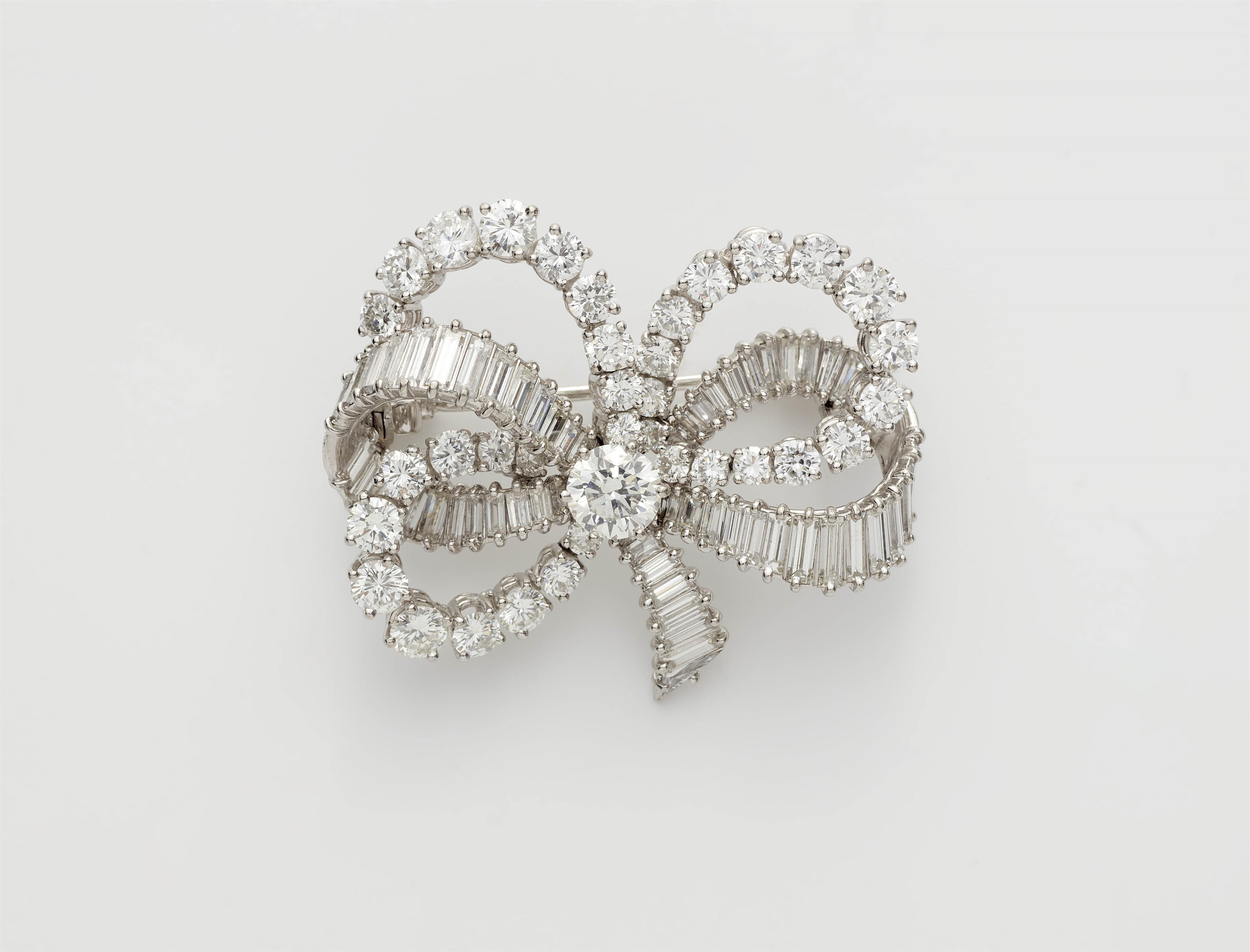 A French 18k gold platinum and diamond bow brooch. - image-1