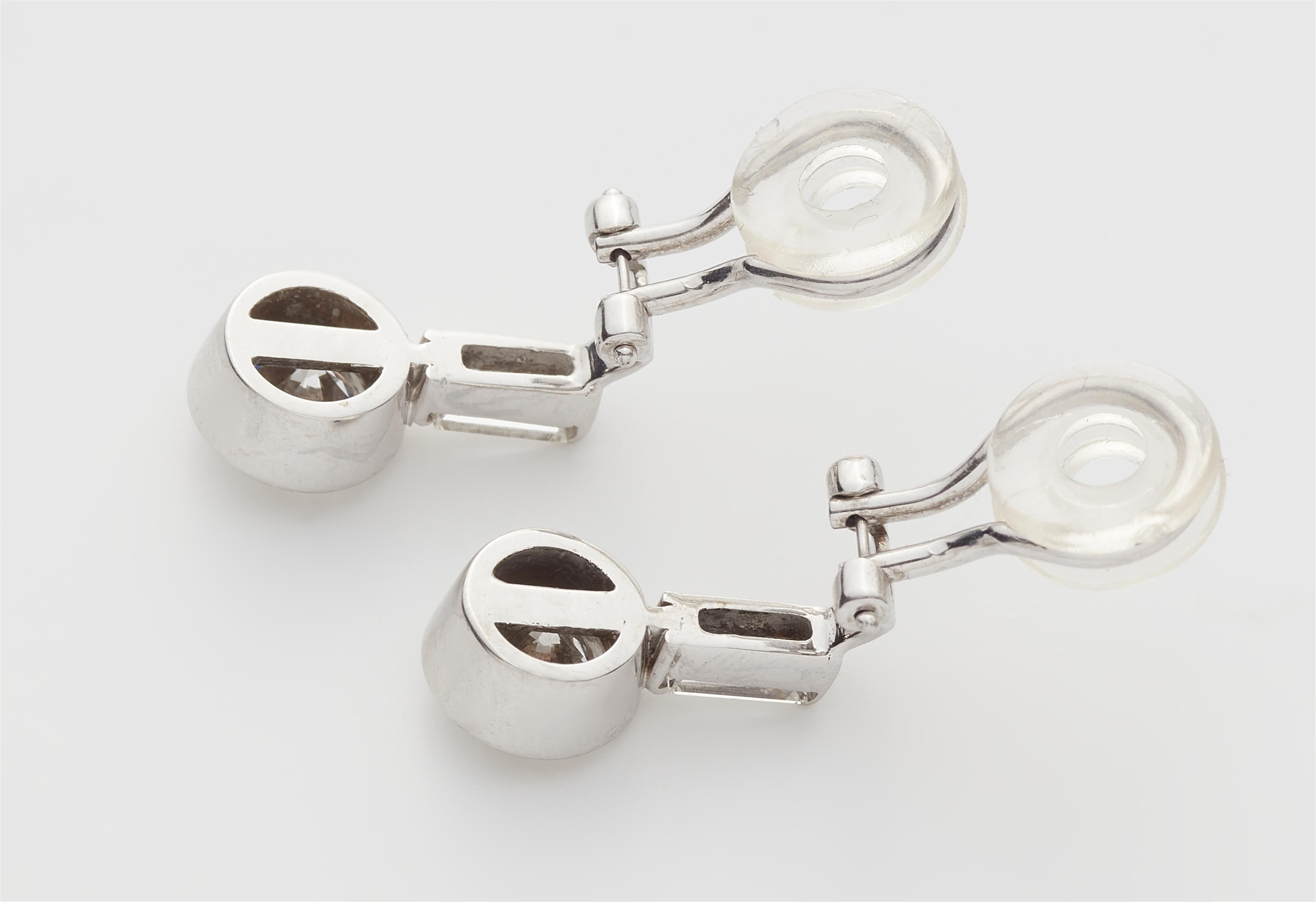 A pair of 18k white gold diamond clip earrings with c. 1.12 ct brilliant-cut diamond solitaires. - image-2
