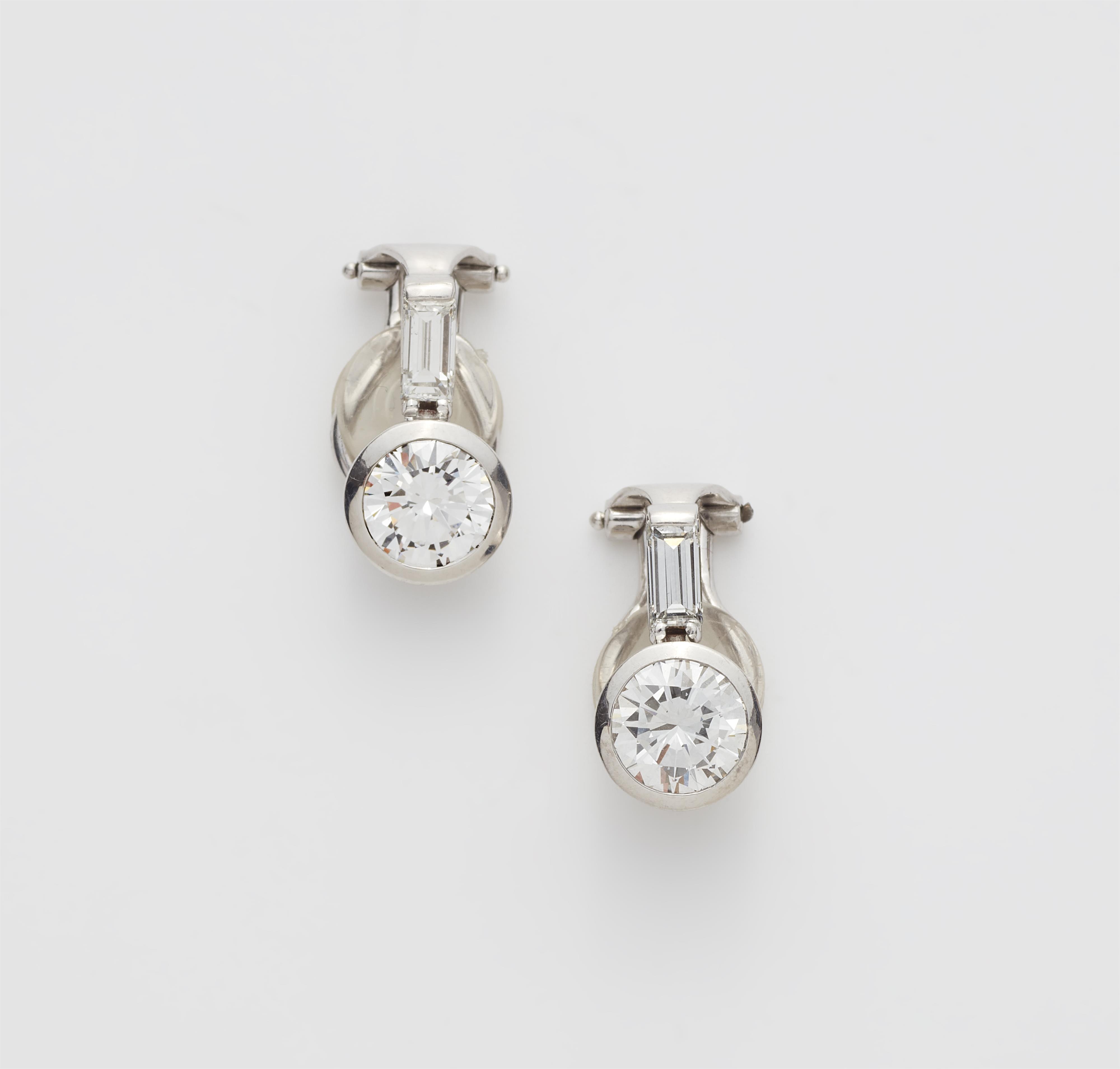 A pair of 18k white gold diamond clip earrings with c. 1.12 ct brilliant-cut diamond solitaires. - image-1